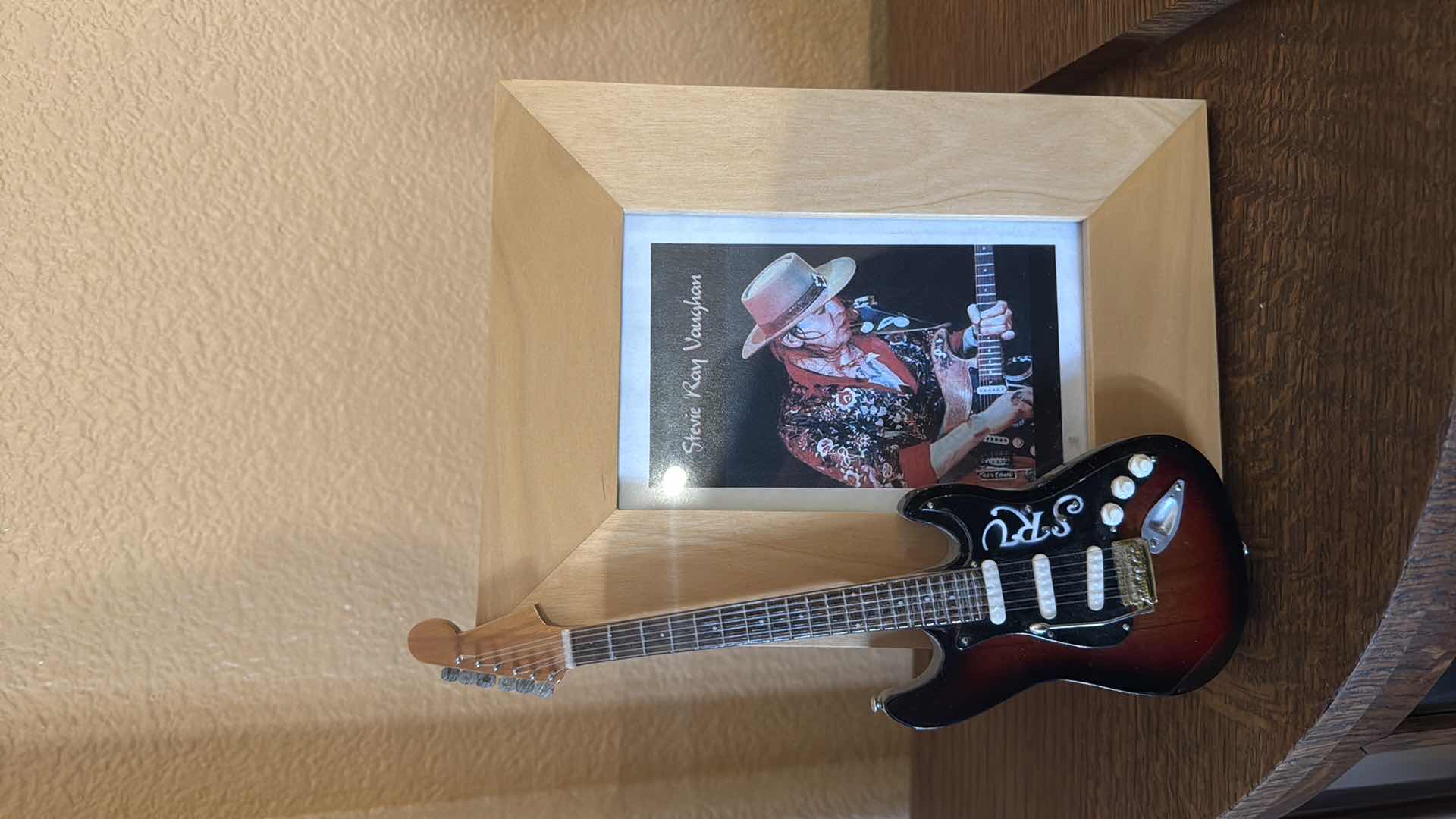 Photo 1 of FRAMED STEVIE RAY VAUGHN WITH MINIATURE COLLECTABLE GUITAR H9”