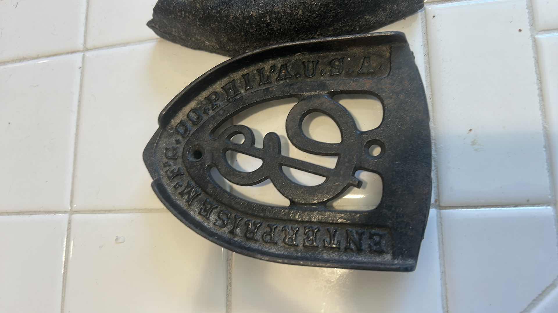 Photo 1 of ANTIQUE SAD IRON AND MATCHING TRIVET