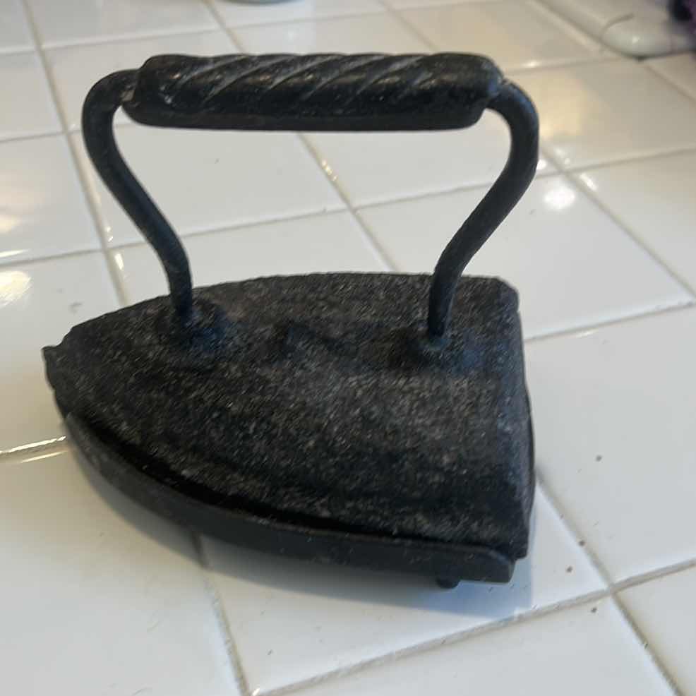 Photo 1 of ANTIQUE SAD IRON AND MATCHING TRIVET