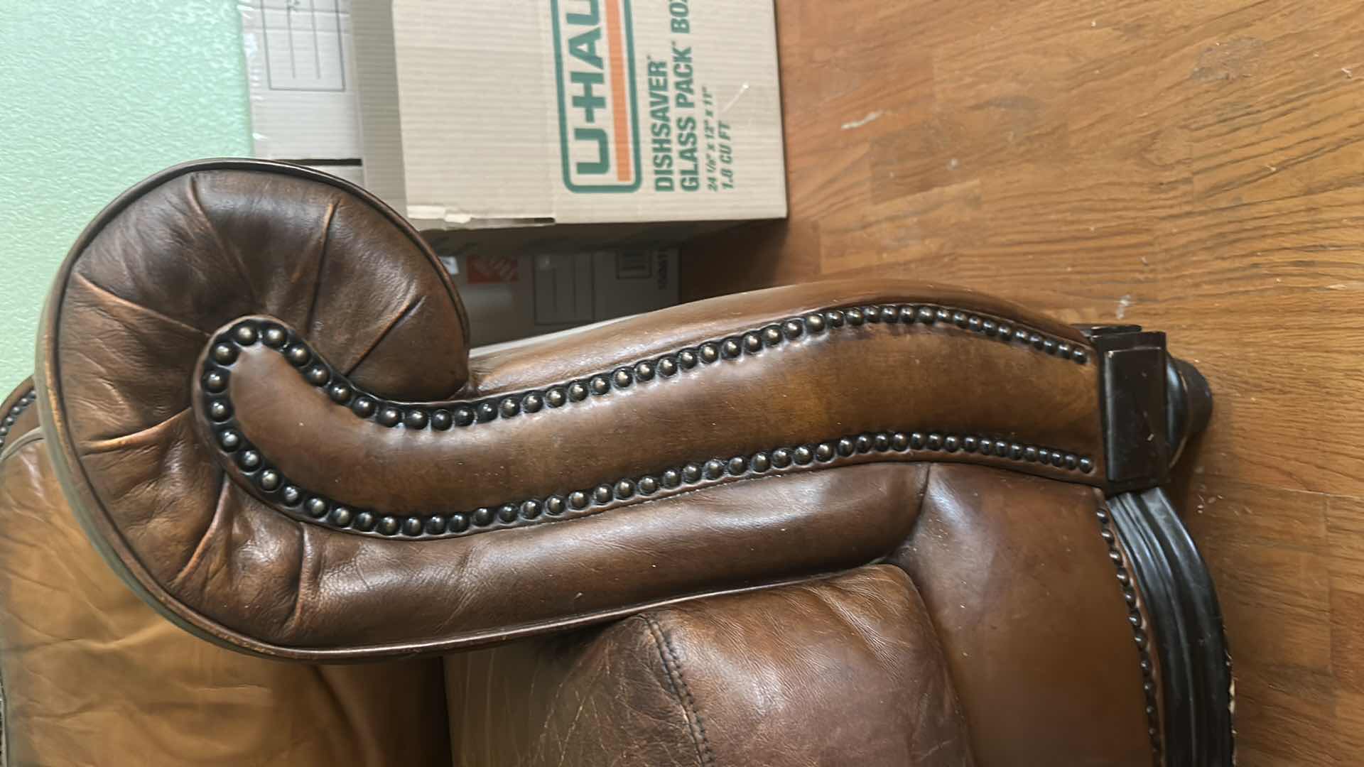 Photo 1 of BROWN LEATHER LOVESEAT WITH NAIL HEAD TRIM AND WOOD BASE & LEGS  69“ x 39“ x H36“