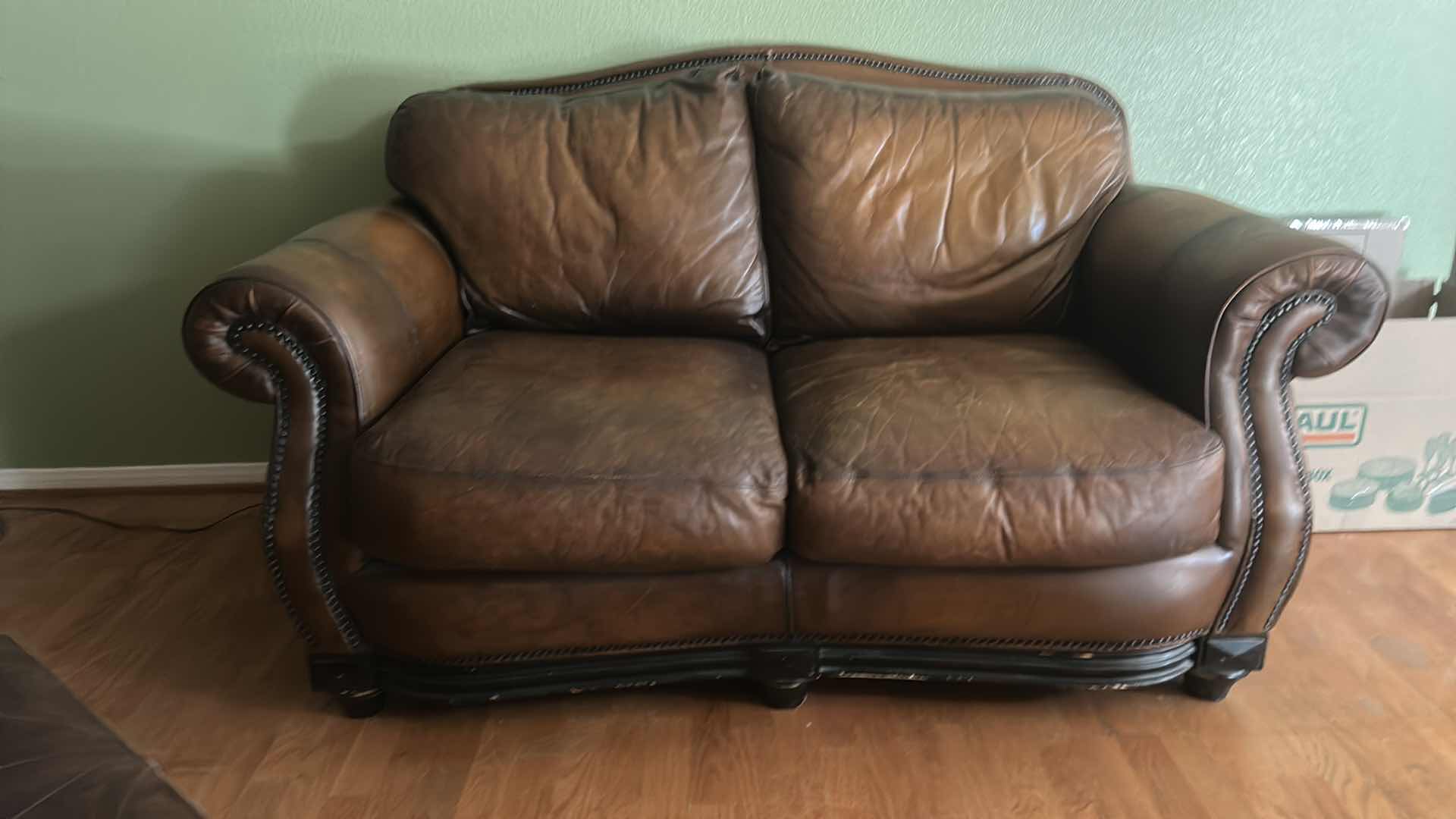Photo 1 of BROWN LEATHER LOVESEAT WITH NAIL HEAD TRIM AND WOOD BASE & LEGS  69“ x 39“ x H36“