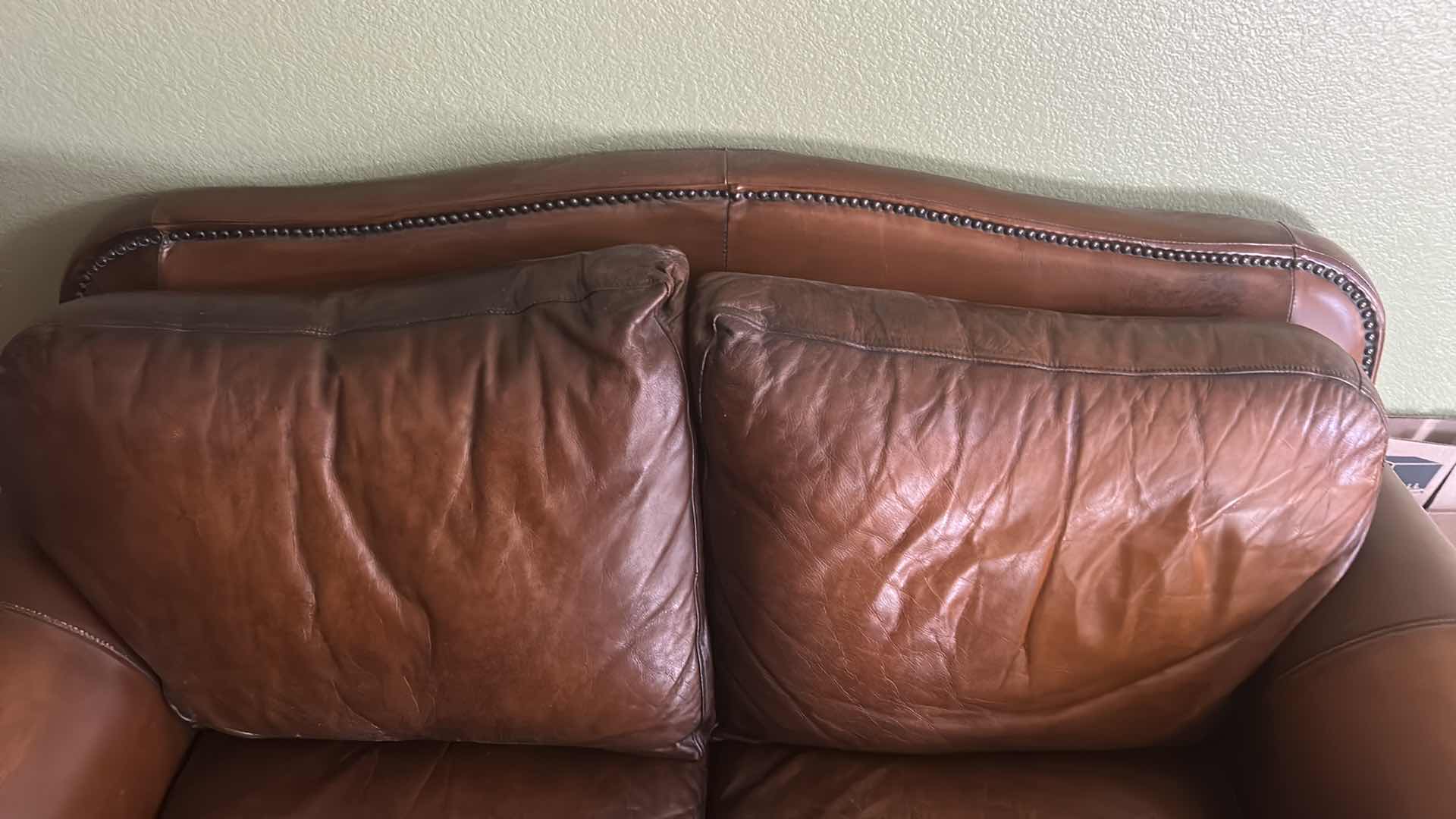 Photo 1 of BROWN LEATHER LOVESEAT WITH NAIL HEAD TRIM AND WOOD BASE & LEGS  69“ x 39“ x H36“
