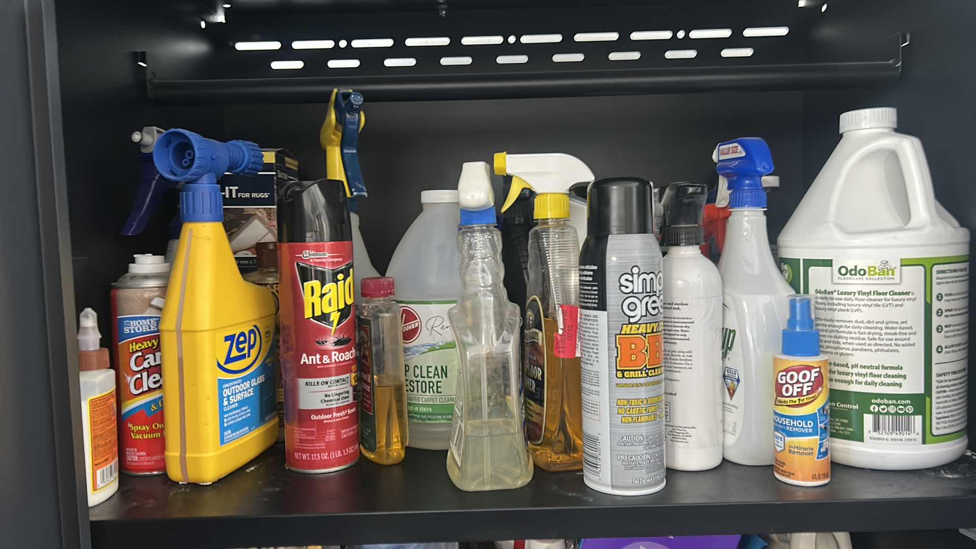 Photo 1 of CLEANING SUPPLIES ON SHELVES IN CABINET