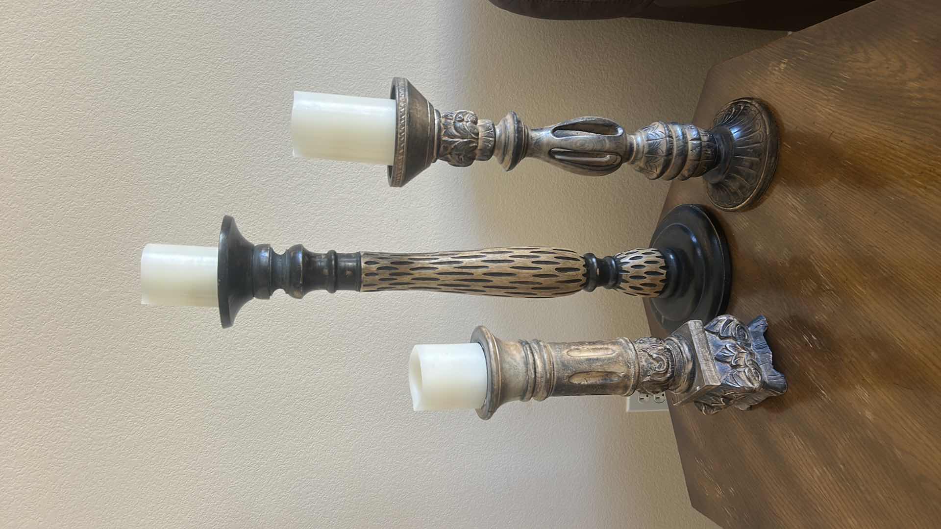 Photo 1 of SET OF THREE DECORATIVE CANDLE HOLDERS IN VARIED HEIGHTS. CARVED WOOD  WITH A DISTRESSED FINISH. (TALLEST H25 1/2”)