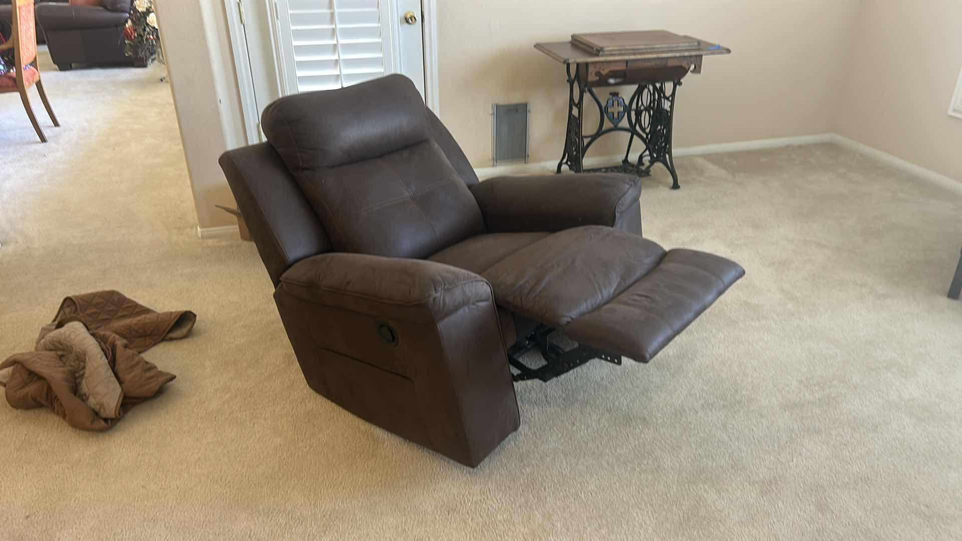 Photo 1 of ASHLEY FURNITURE ROCKER RECLINER WITH LEATHER-LOOK UPHOLSTERY. MADE OF POLYURETHANE, POLYESTER, AND FIBER MATERIALS.