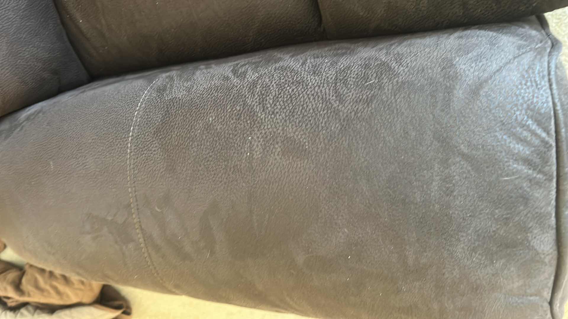 Photo 1 of ASHLEY FURNITURE ROCKER RECLINER WITH LEATHER-LOOK UPHOLSTERY. MADE OF POLYURETHANE, POLYESTER, AND FIBER MATERIALS.