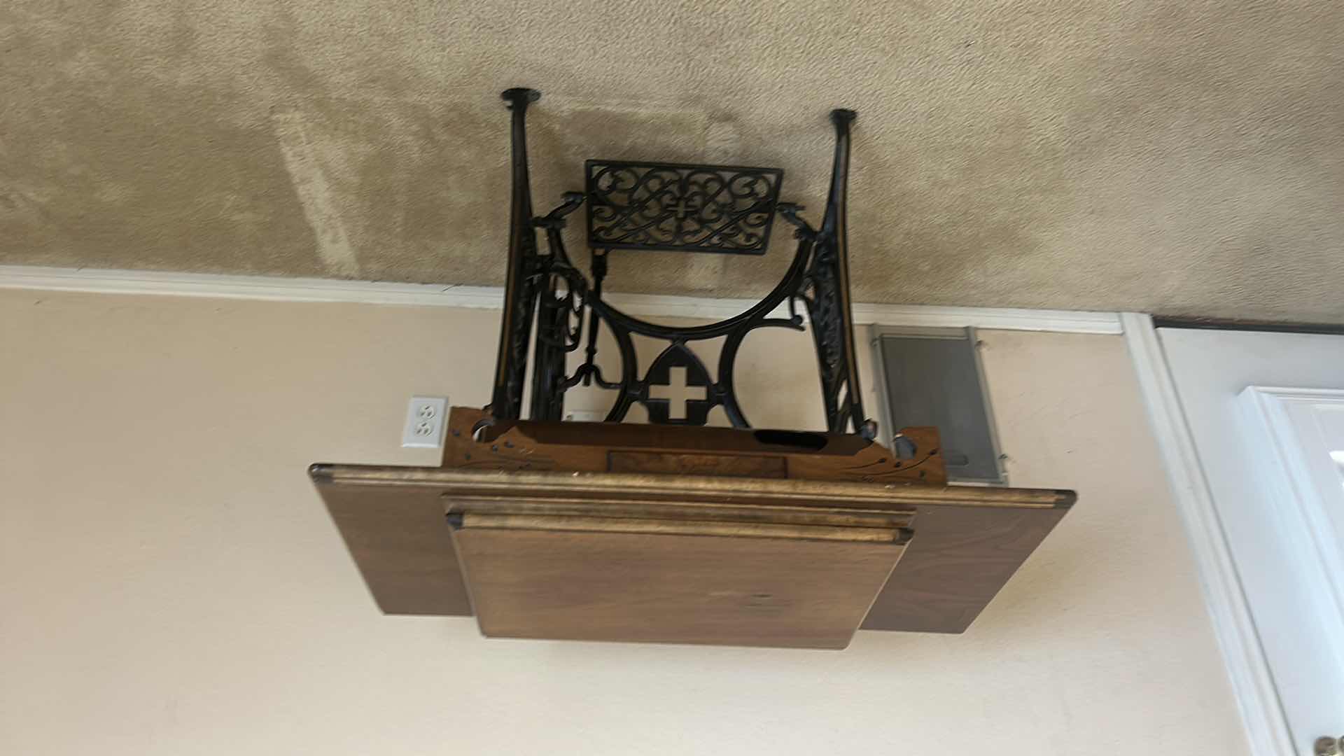 Photo 1 of ANTIQUE HELVETIA TREADLE SEWING MACHINE AND CABINET, ORNATE CAST IRON AND GOLD DETAILING PLUS PARTS. INCLUDES CAST IRON TREADLE BASE, SEWING MACHINE HEAD, WOOD TABLE TOP, DRAWERS, AND LOOSE WOOD COMPONENTS. 
36 1/2“ x 18 1/2“ x H32“