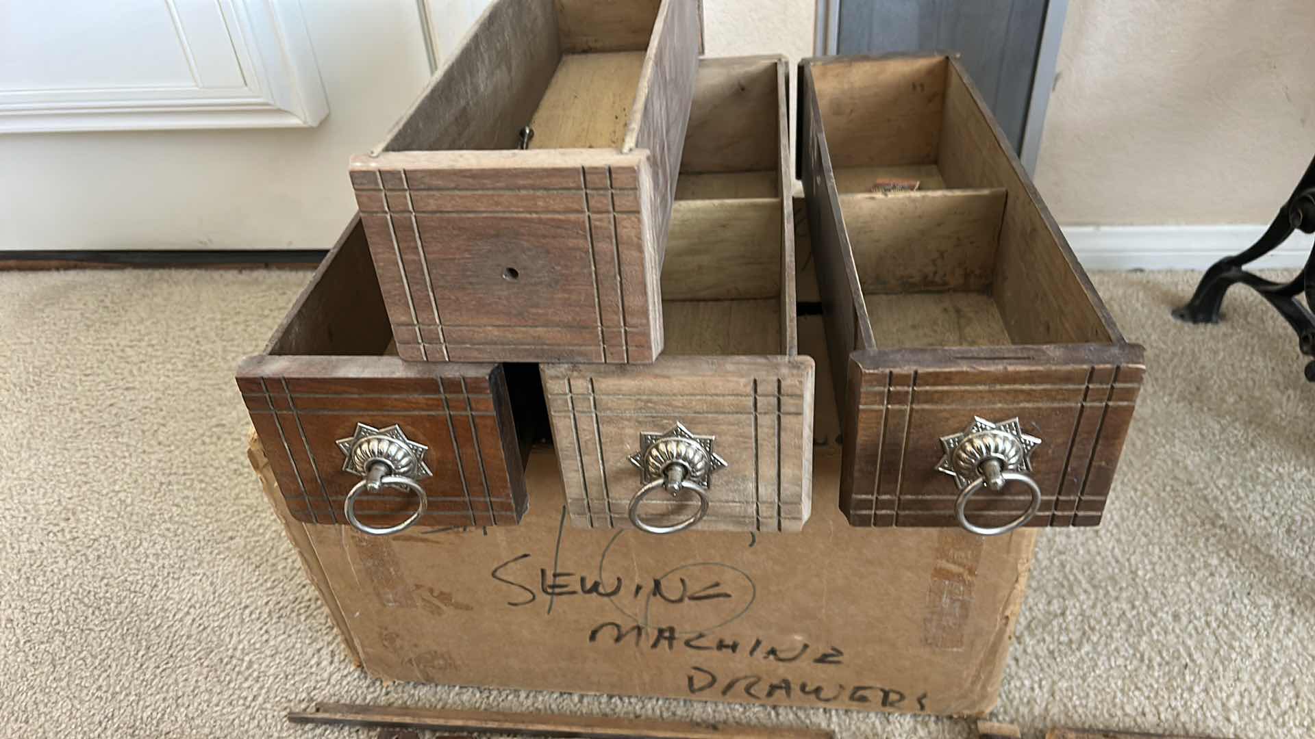 Photo 1 of ANTIQUE HELVETIA TREADLE SEWING MACHINE AND CABINET, ORNATE CAST IRON AND GOLD DETAILING PLUS PARTS. INCLUDES CAST IRON TREADLE BASE, SEWING MACHINE HEAD, WOOD TABLE TOP, DRAWERS, AND LOOSE WOOD COMPONENTS. 
36 1/2“ x 18 1/2“ x H32“