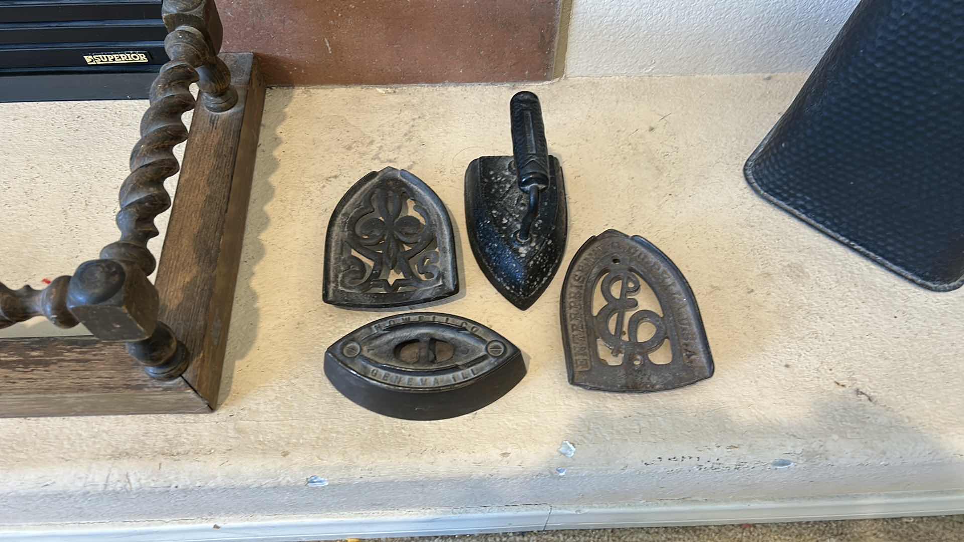 Photo 1 of ANTIQUE CAST IRON IRONS AND IRON TRIVETS. INCLUDES SAD IRONS AND DECORATIVE IRON RESTS