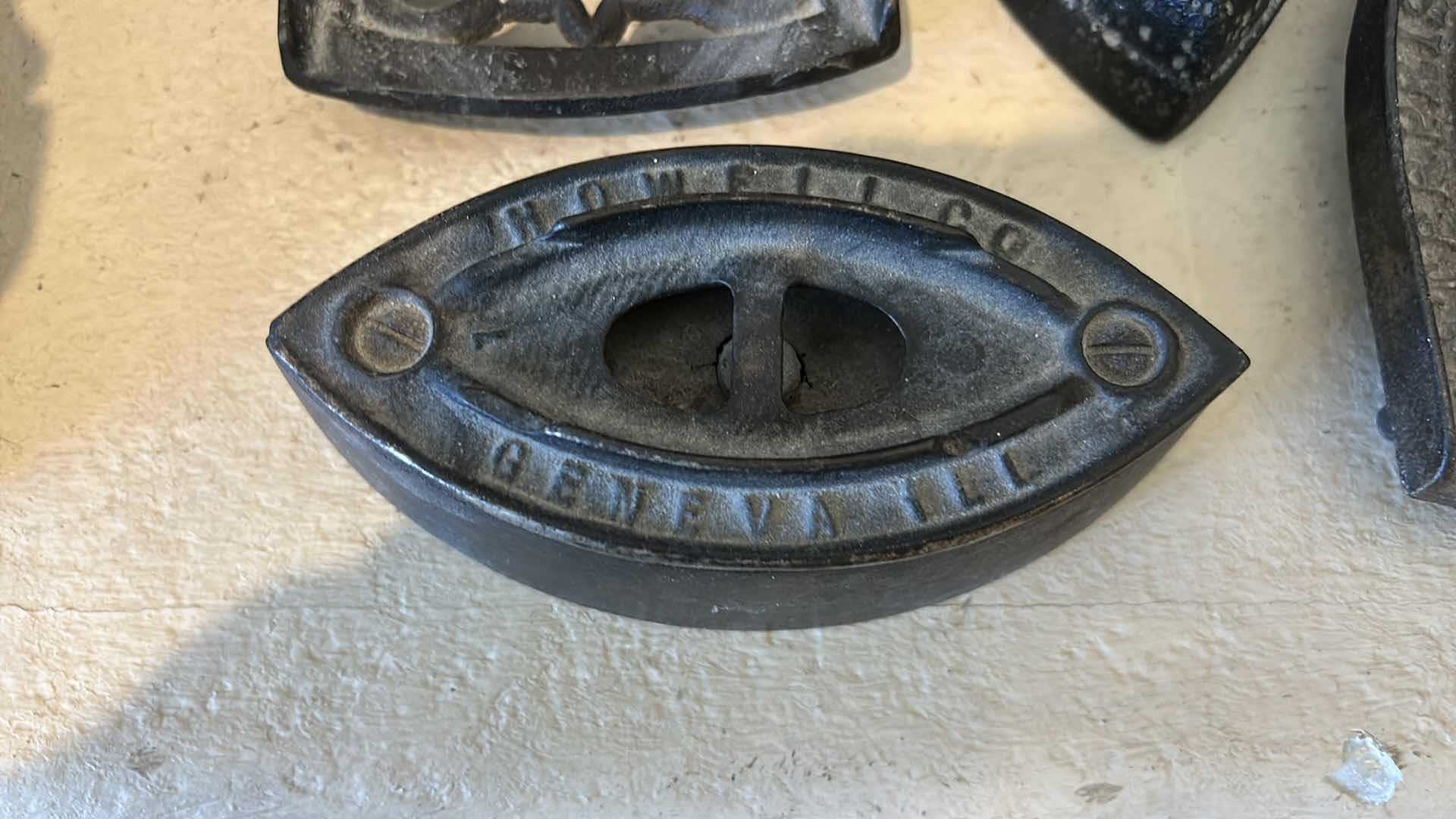 Photo 1 of ANTIQUE CAST IRON IRONS AND IRON TRIVETS. INCLUDES SAD IRONS AND DECORATIVE IRON RESTS