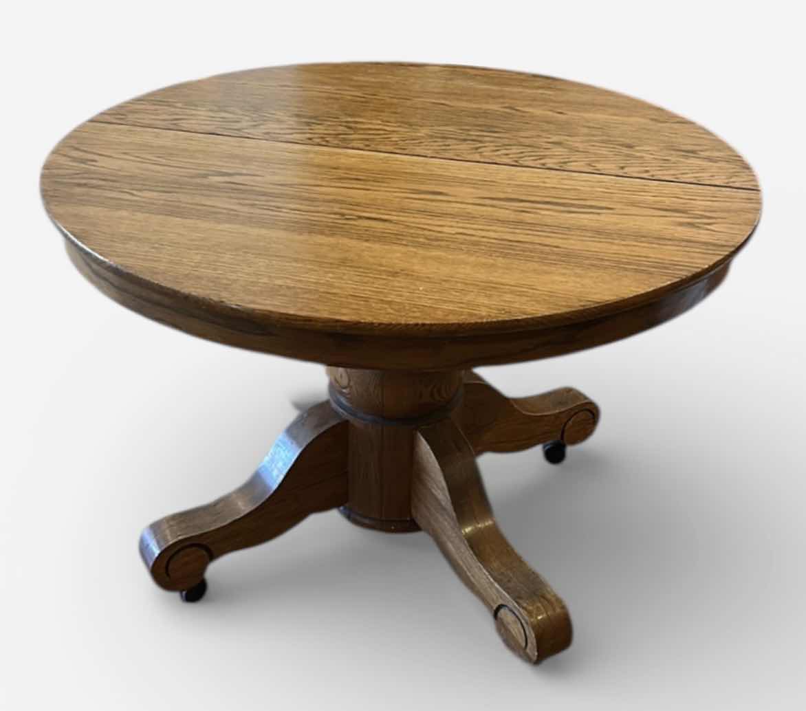 Photo 1 of ANTIQUE OAK ROUND PEDESTAL DINING TABLE  ON CASTERS. 43 1/2“ x H30 1/2“ PLUS 3 9.5” LEAFS