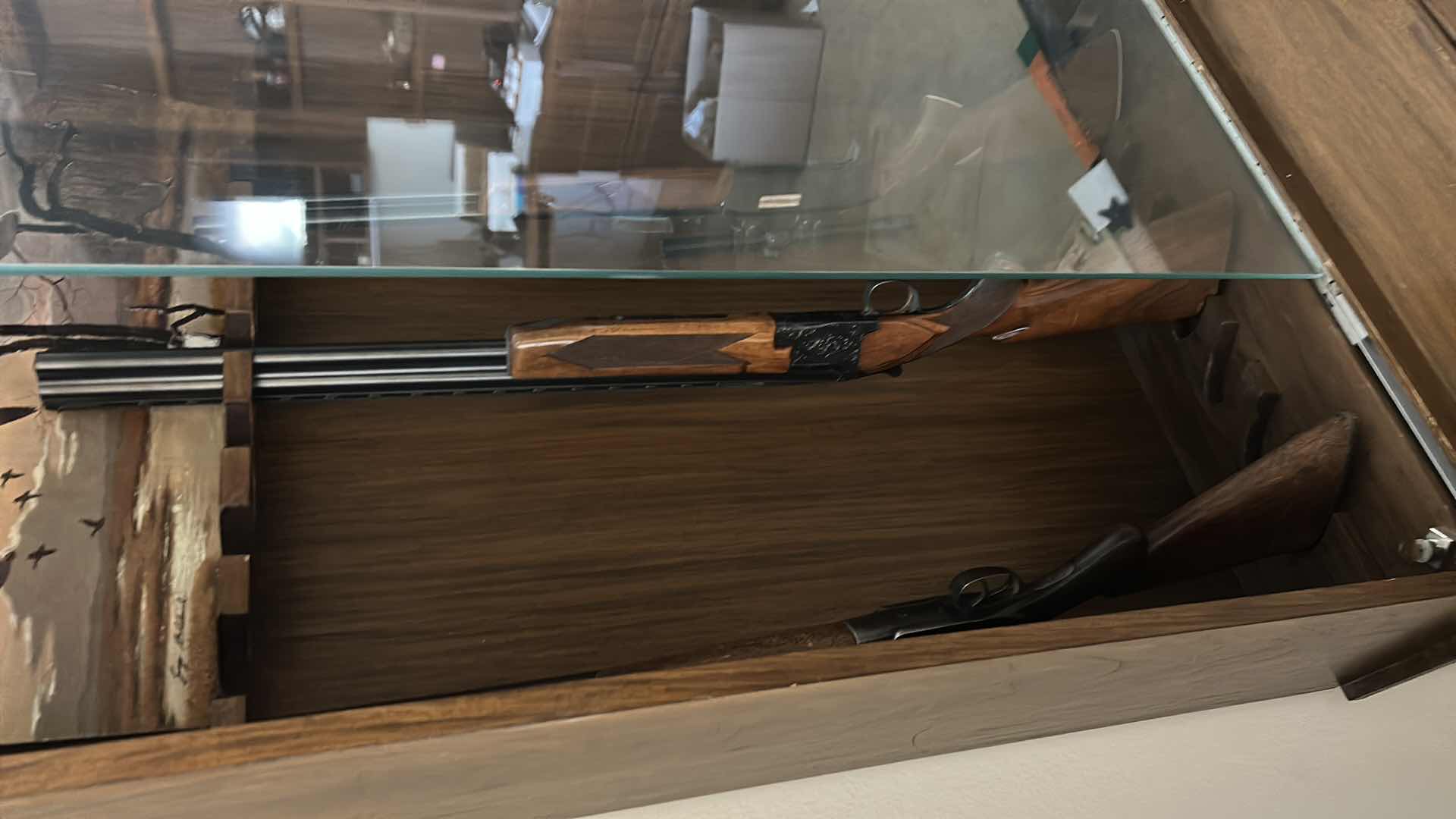 Photo 1 of WOODEN GUN CABINET WITH GLASS FRONT. FEATURES CARVED WOOD DOORS ON LOWER CABINET AND LOCKING STORAGE. DESIGNED TO DISPLAY AND STORE FIREARMS. HOLDS 8,  LOWER CABINET 33 1/4 x 16“ x H22“ , TOP CABINET  32“ x 10 1/2“ x H54 1/2“