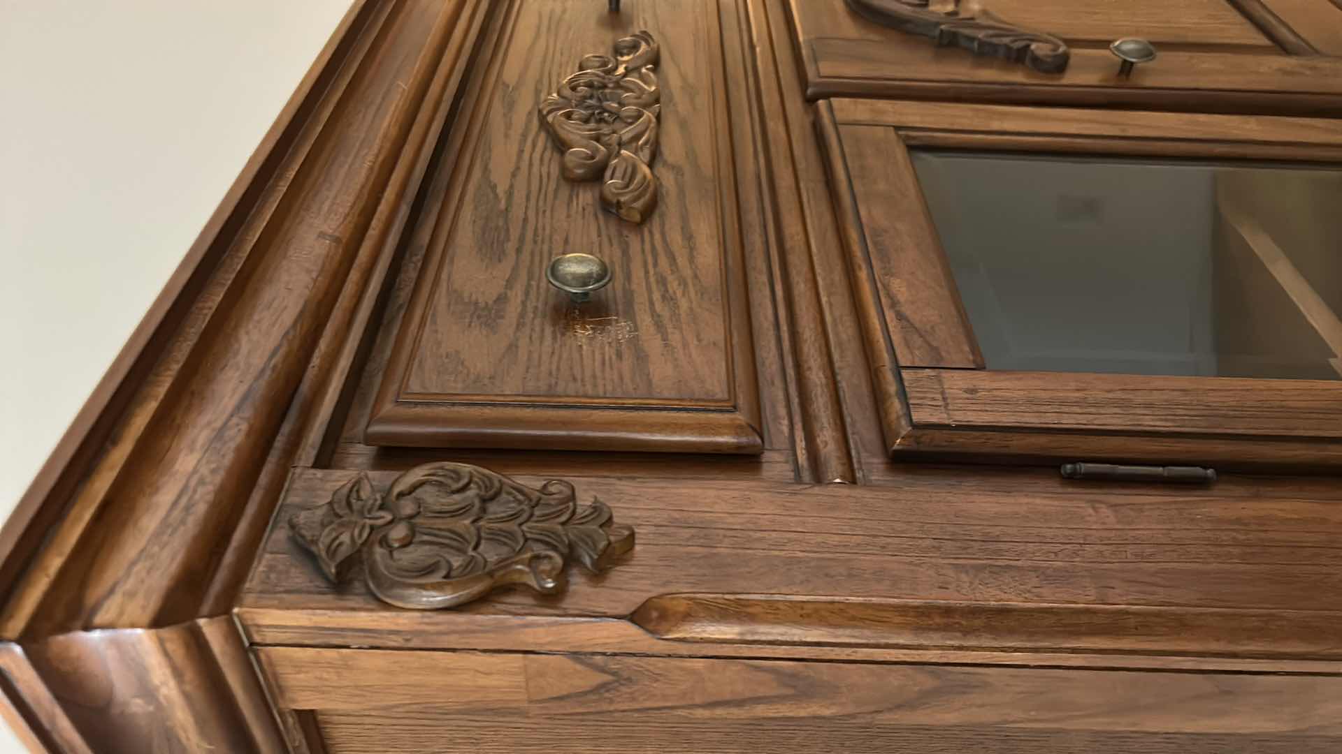 Photo 1 of TRADITIONAL CARVED WOOD HUTCH OR ARMOIRE, OFTEN REFERRED TO AS A CHINA CABINET. FEATURES DARK CHERRY OR WALNUT FINISH WITH GLASS-PANELED DOORS AND DRAWERS FOR STORAGE. 54 1/2” x 19” x H65” TONGUE AND GROOVE