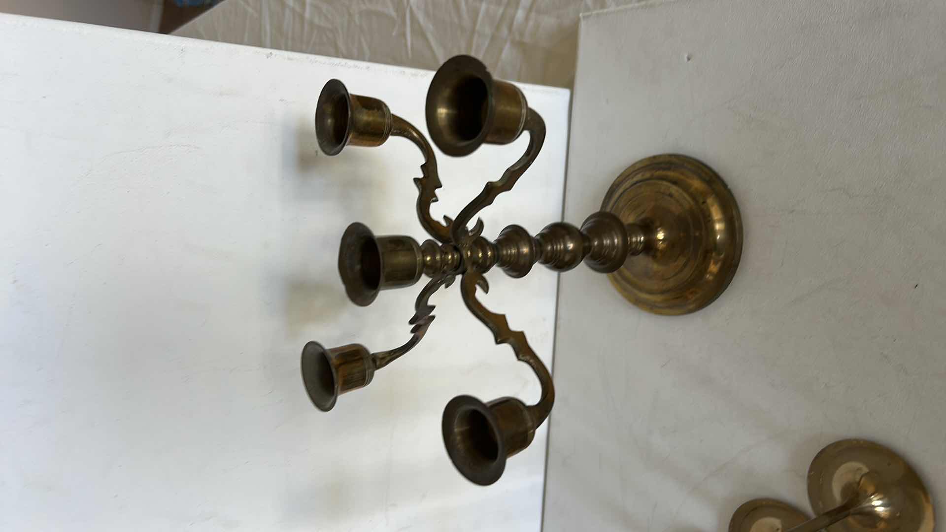 Photo 1 of BRASS CANDLE HOLDERS AND CANDLE ACCESSORIES. INCLUDES MULTIPLE TALL TAPER HOLDERS, A MULTI-ARM CANDELABRA H10” AND A BRASS CUP.