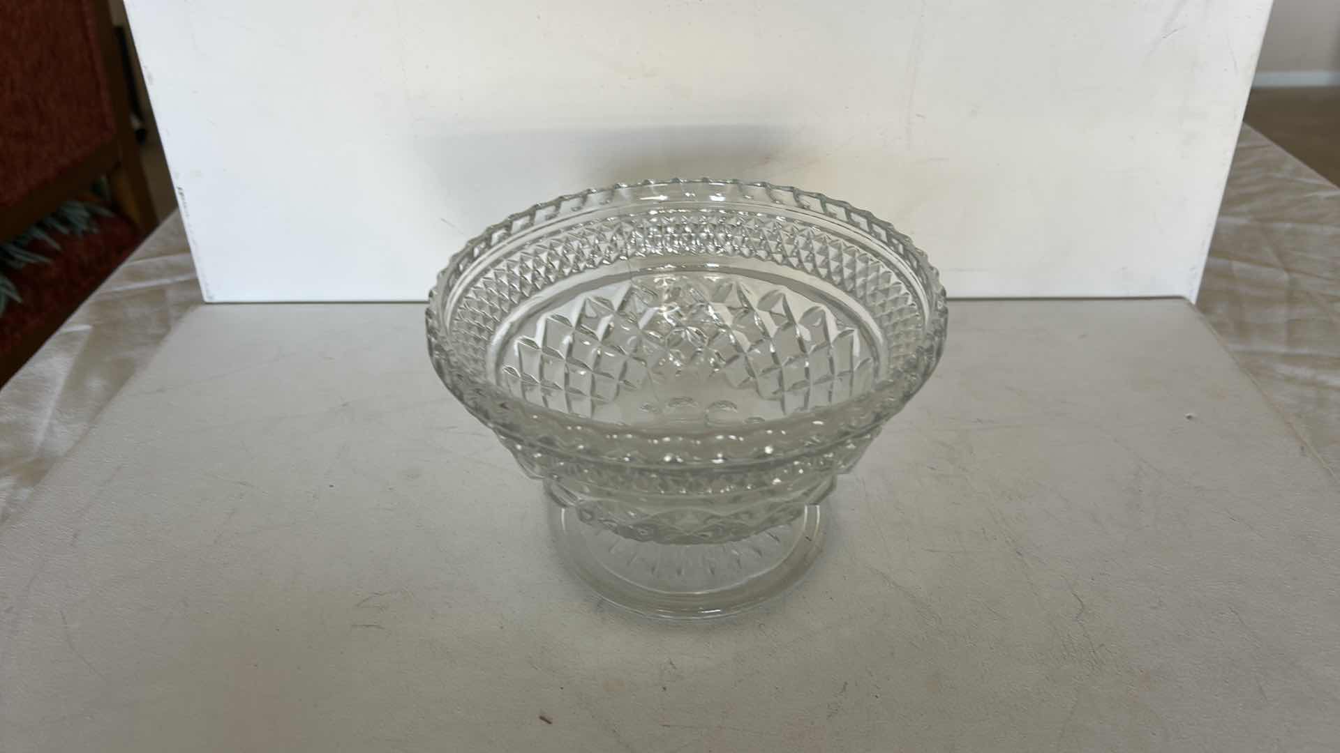 Photo 1 of SET OF TWO CLEAR PRESSED GLASS BOWLS. ONE OVAL SERVING BOWL AND ONE PEDESTAL BOWL H4.25”WITH CUT PATTERN DESIGN.