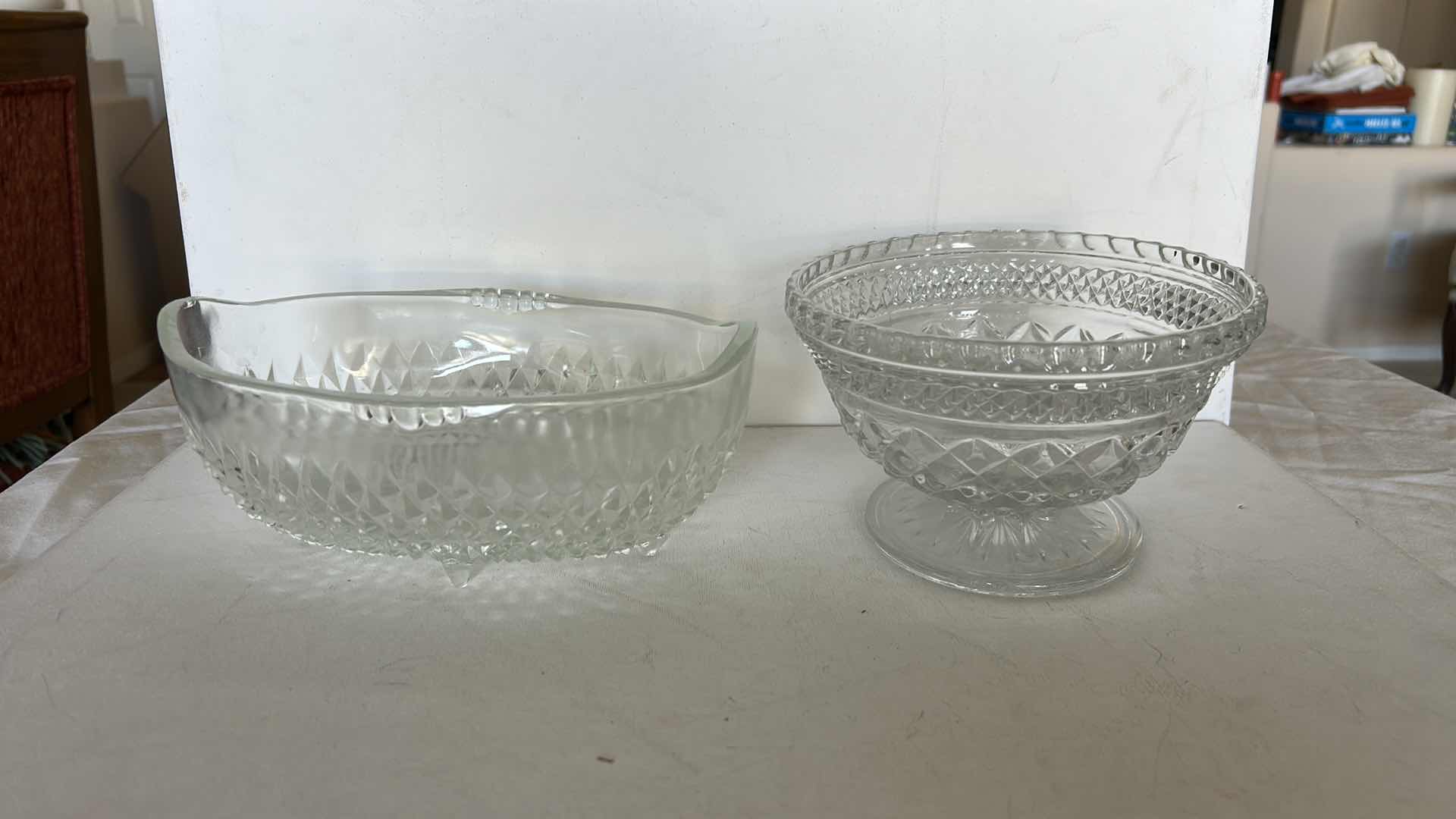 Photo 1 of SET OF TWO CLEAR PRESSED GLASS BOWLS. ONE OVAL SERVING BOWL AND ONE PEDESTAL BOWL H4.25”WITH CUT PATTERN DESIGN.