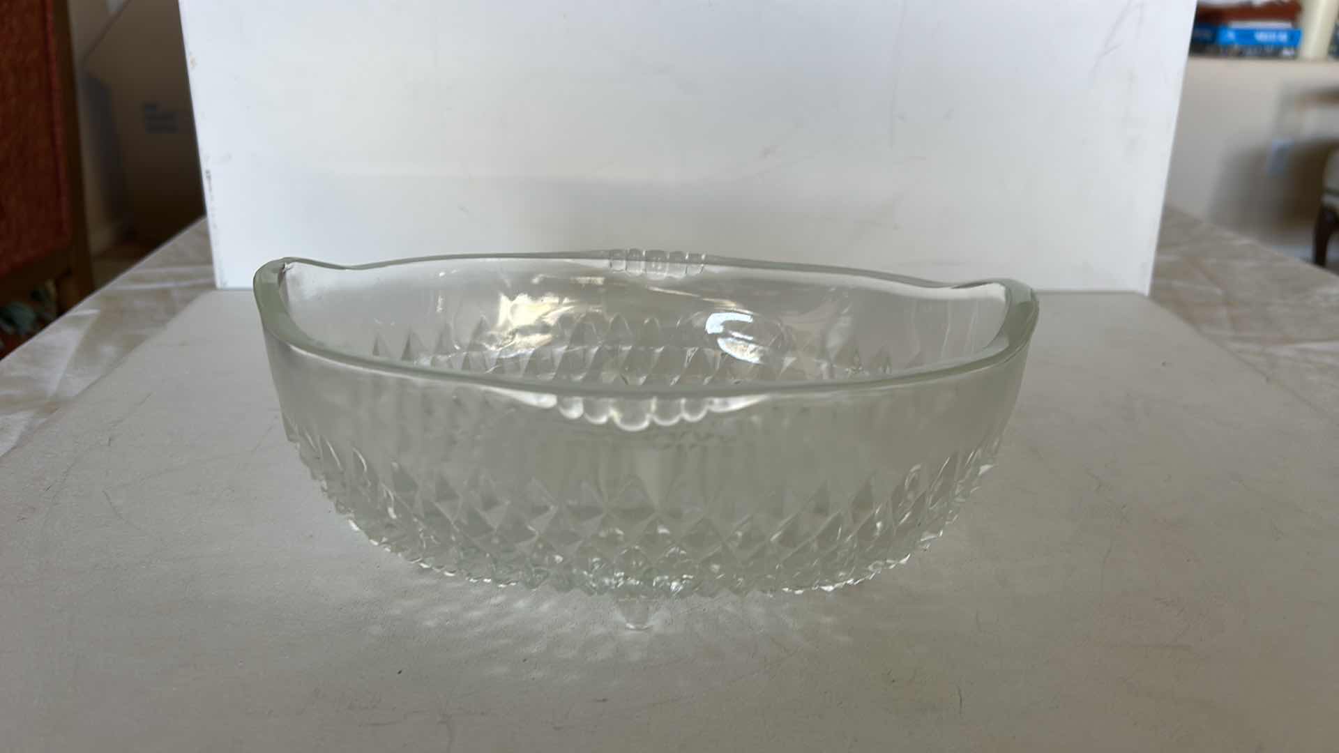 Photo 1 of SET OF TWO CLEAR PRESSED GLASS BOWLS. ONE OVAL SERVING BOWL AND ONE PEDESTAL BOWL H4.25”WITH CUT PATTERN DESIGN.
