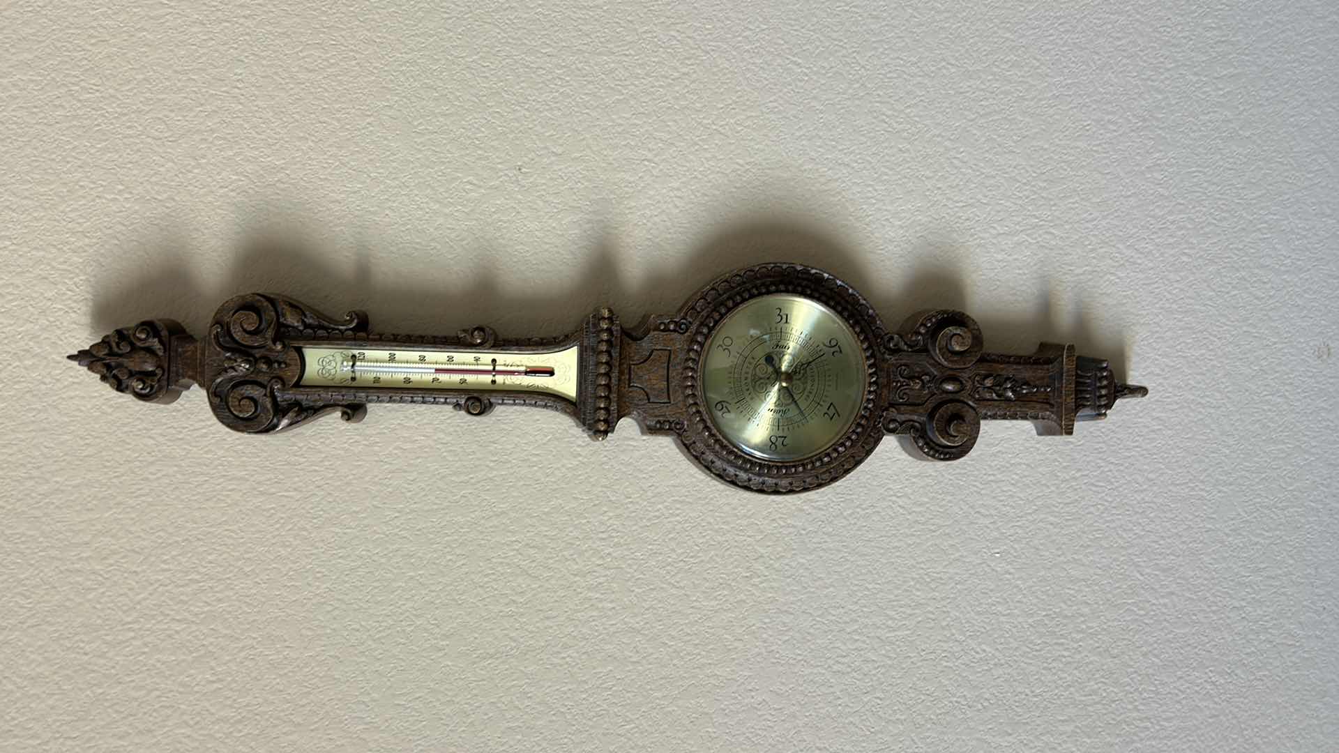 Photo 1 of ANTIQUE STYLE WALL-MOUNTED BAROMETER AND THERMOMETER. ORNATE DECORATIVE FRAME WITH ROUND DIAL AND VERTICAL TEMPERATURE GAUGE. RESIN H30’