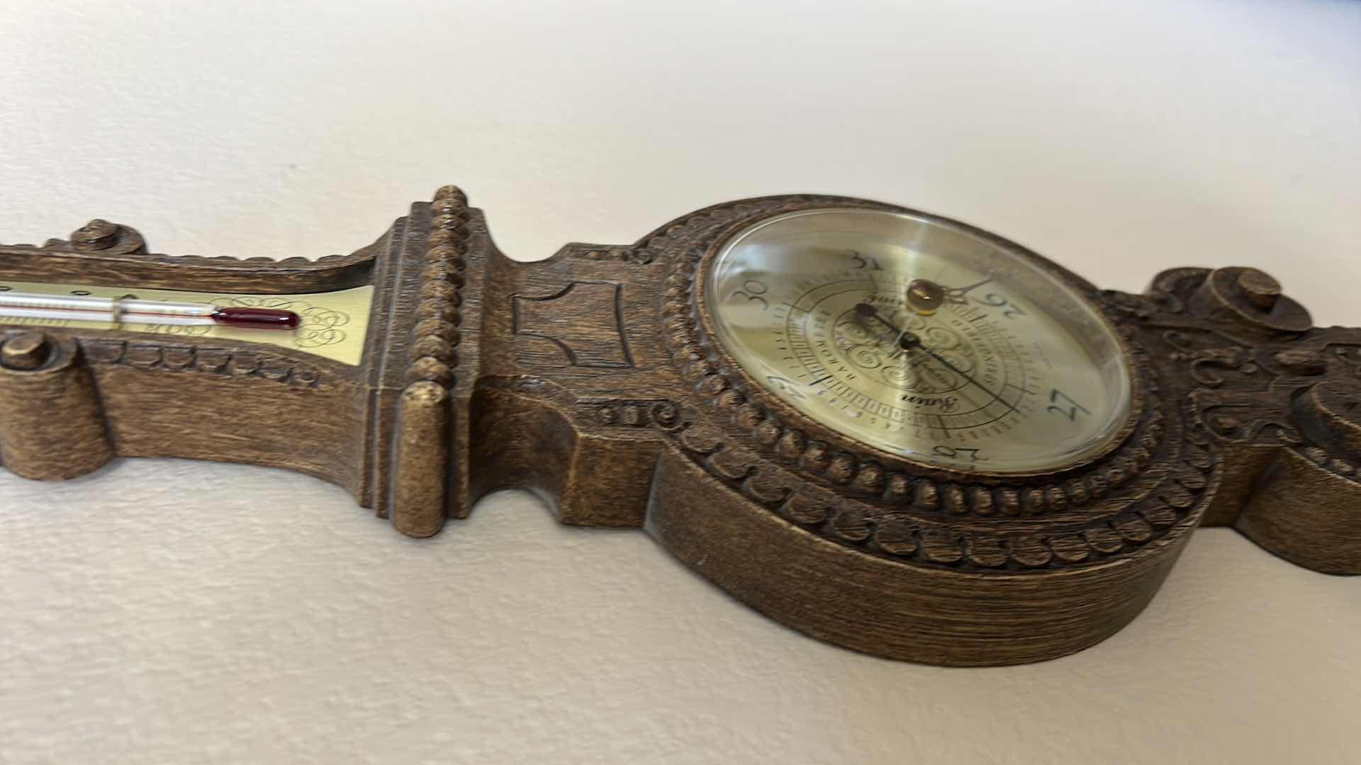 Photo 1 of ANTIQUE STYLE WALL-MOUNTED BAROMETER AND THERMOMETER. ORNATE DECORATIVE FRAME WITH ROUND DIAL AND VERTICAL TEMPERATURE GAUGE. RESIN H30’