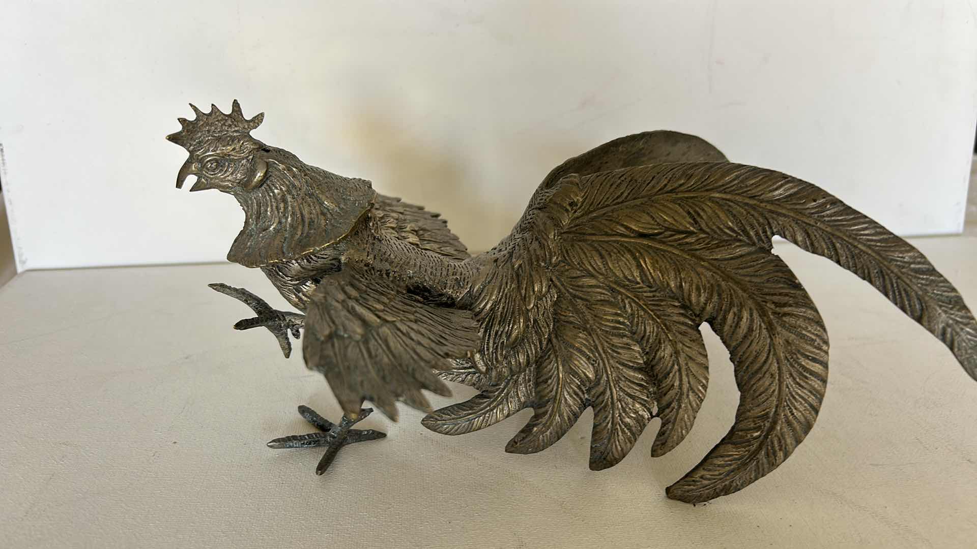 Photo 1 of DECORATIVE METAL ROOSTER FIGURINE WITH DETAILED FEATHER DESIGN. 9” x H4 1/2”