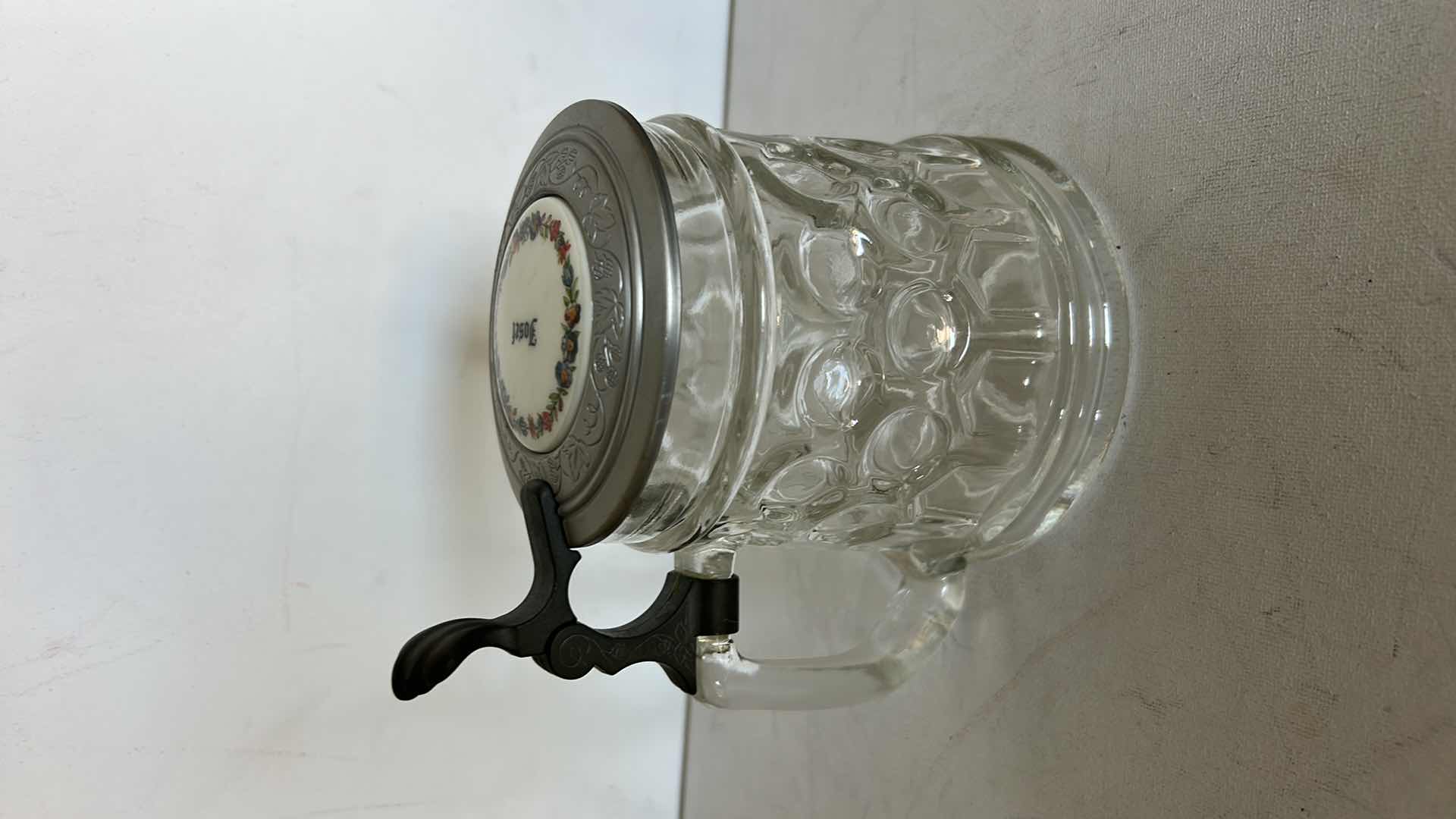 Photo 1 of ORIGINAL BMF SCHNAPSKRUGERL GLASS BEER STEIN.  WITH TEXTURED GLASS BODY AND PEWTER LID. FEATURES A THUMB LIFT HANDLE AND DECORATIVE TOP MEDALLION. H6”