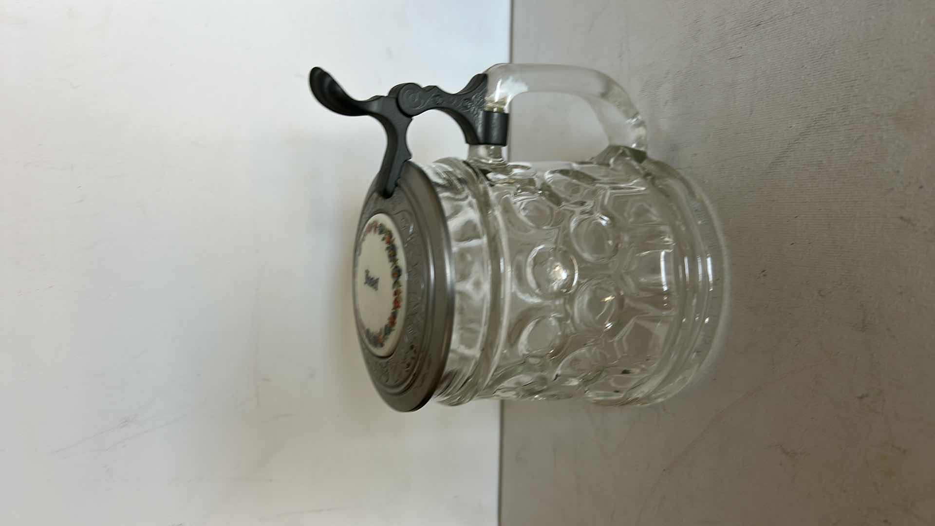 Photo 1 of ORIGINAL BMF SCHNAPSKRUGERL GLASS BEER STEIN.  WITH TEXTURED GLASS BODY AND PEWTER LID. FEATURES A THUMB LIFT HANDLE AND DECORATIVE TOP MEDALLION. H6”