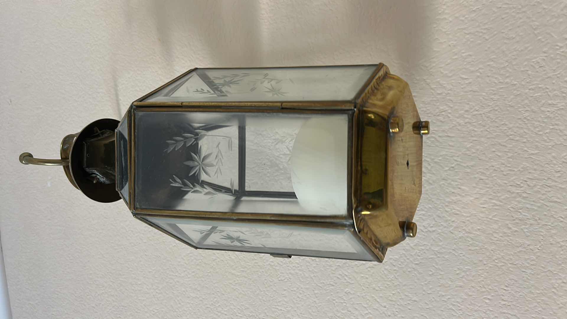 Photo 1 of 2 VINTAGE STYLE WALL-MOUNTED BRASS AND GLASS LANTERN. FEATURES ETCHED GLASS PANELS. (H20” FROM WALL HOOK TO BOTTOM)