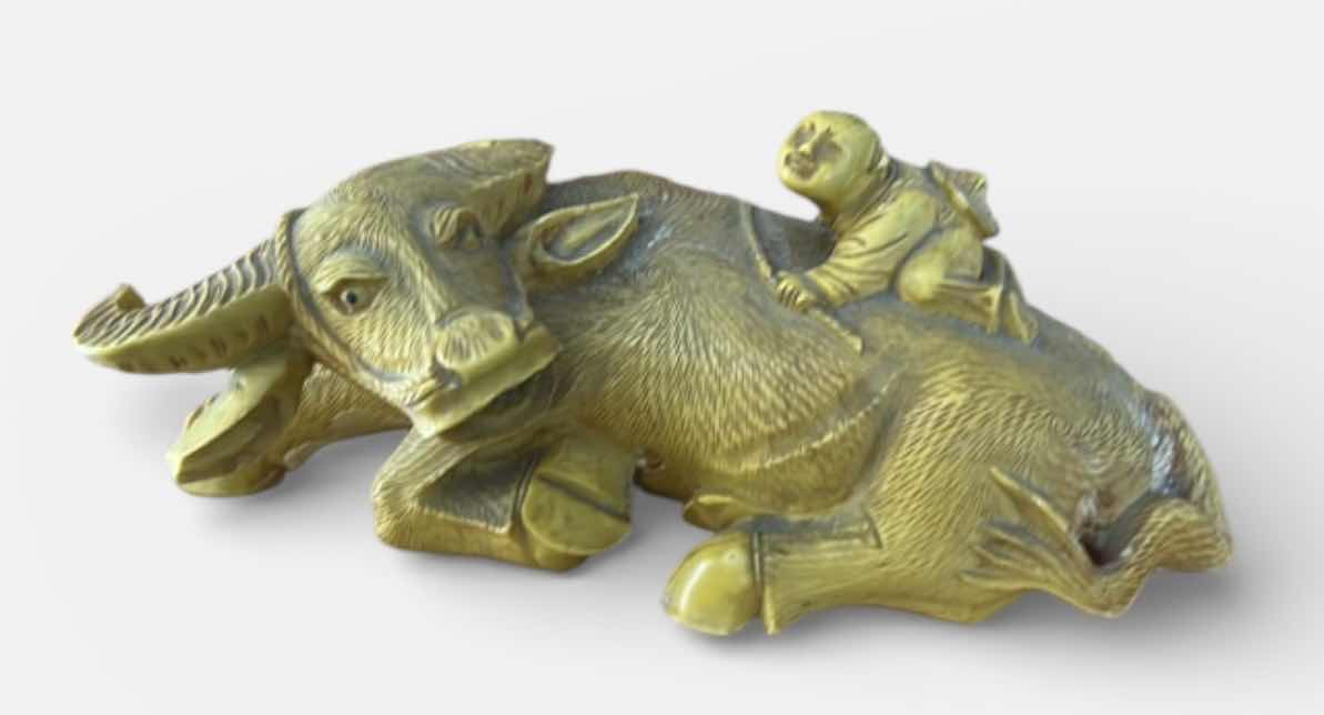 Photo 1 of RESIN SHEPHERD BOY RIDING A WATER BUFFALO, COMMONLY MARKETED AS A CHINESE FENG SHUI WEALTH SYMBOL. 9” x H4”