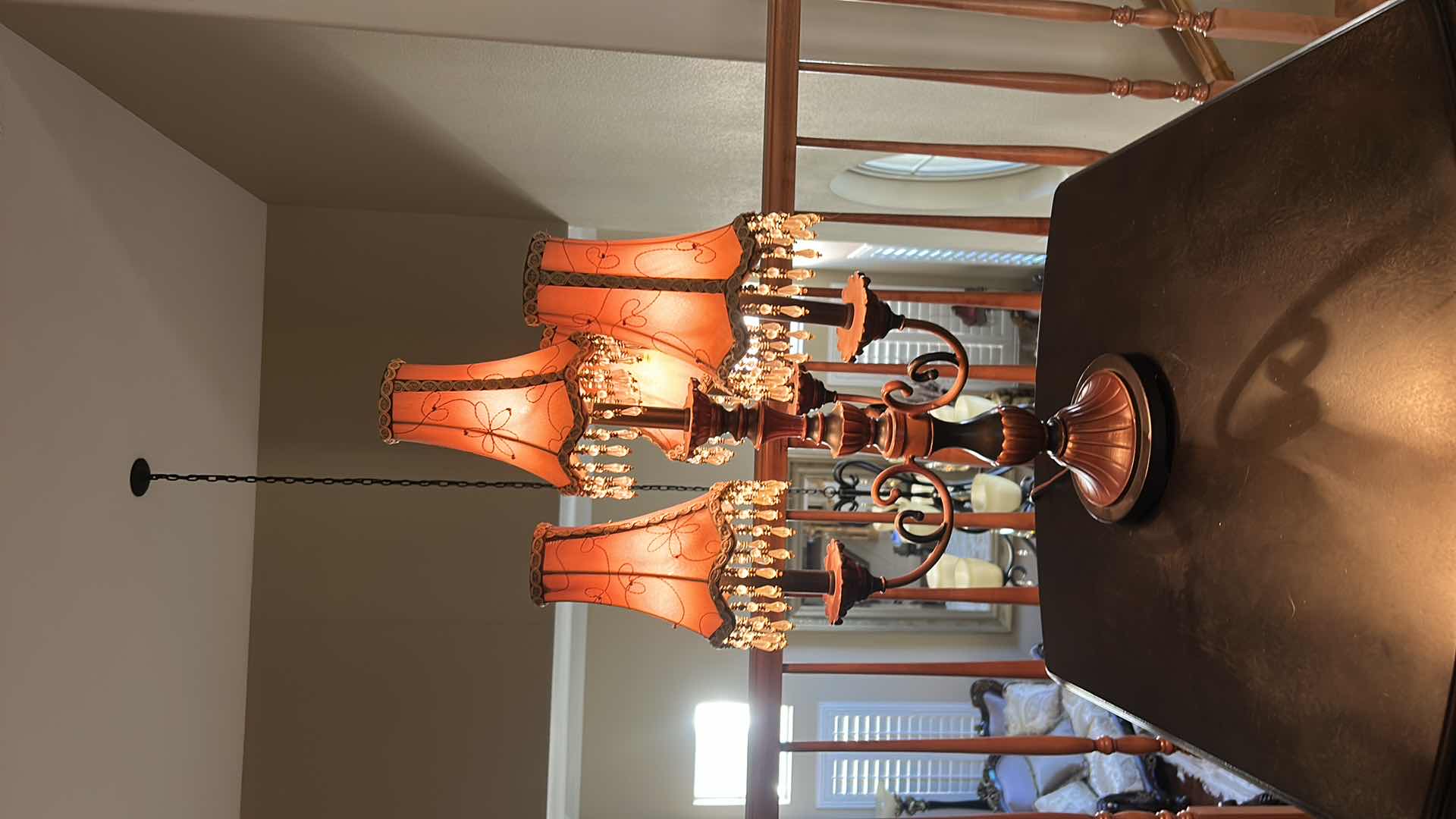 Photo 1 of THREE-LIGHT TABLE LAMP WITH METAL BASE AND SCROLL ARMS, ORANGE FABRIC SHADES WITH BEADED FRINGE H29.5”