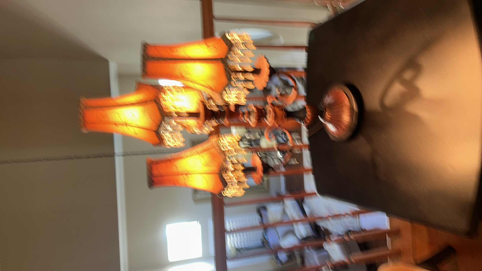 Photo 1 of THREE-LIGHT TABLE LAMP WITH METAL BASE AND SCROLL ARMS, ORANGE FABRIC SHADES WITH BEADED FRINGE H29.5”