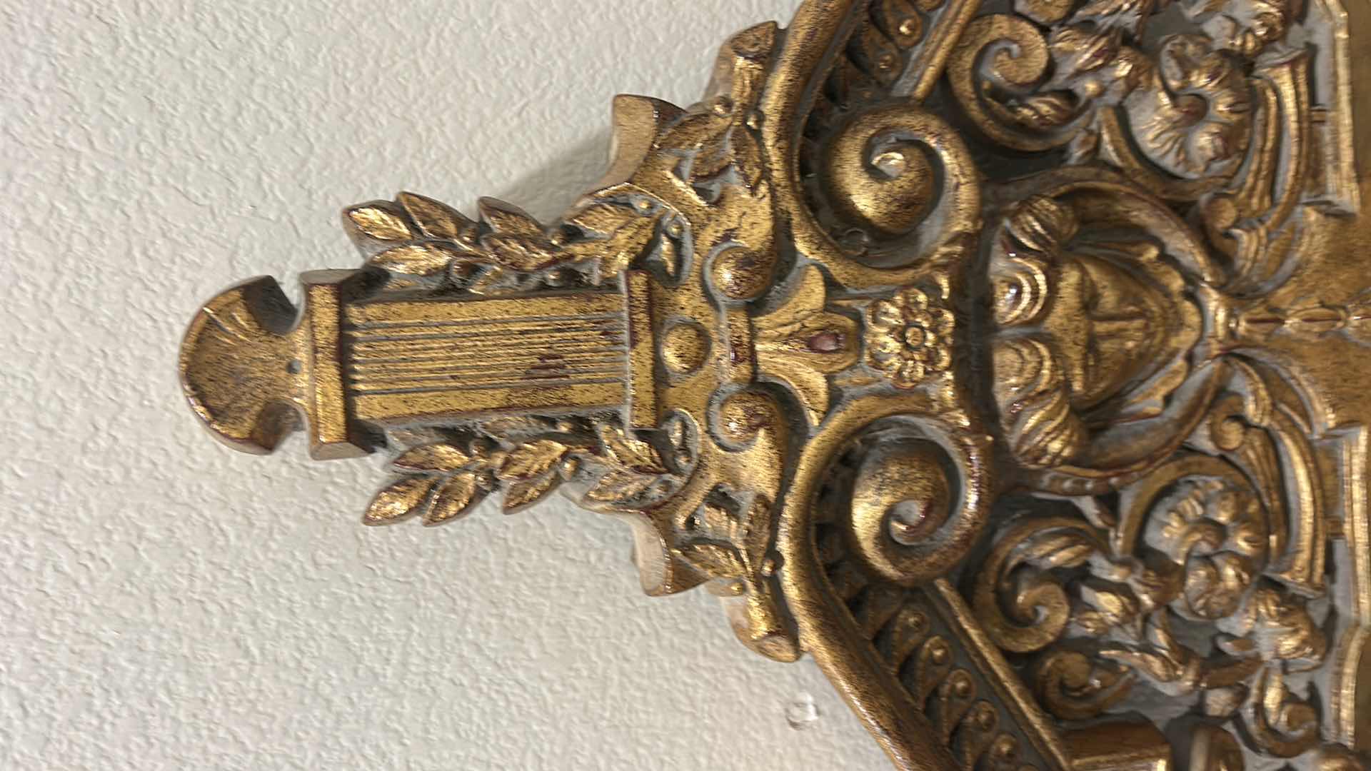 Photo 1 of ITALIAN BAROQUE-STYLE FIGURAL MIRROR FEATURING A GOLD GILT FINISH, A LARGE CENTRAL FEMALE FACE CREST, AND WINGED GRIFFINS ON THE BASE. 25” x H53“