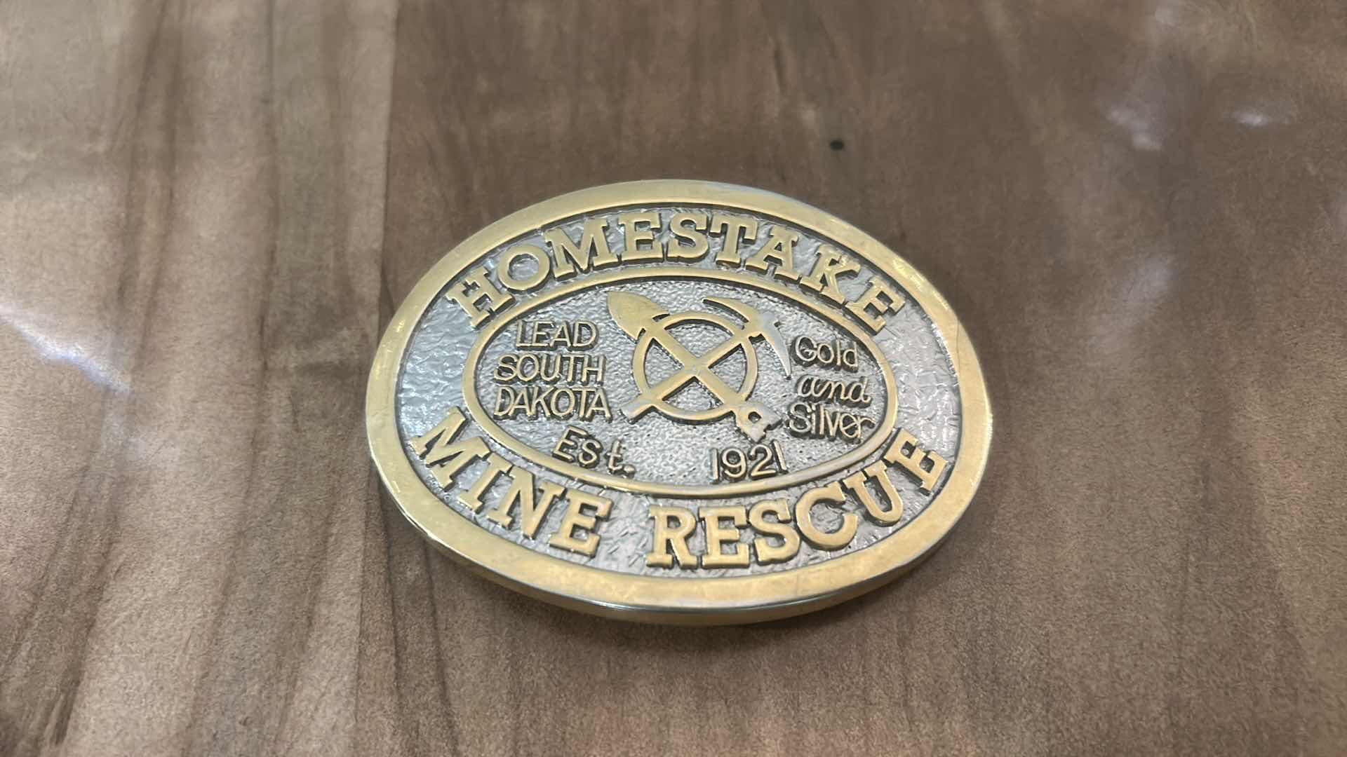 Photo 1 of COLLECTIBLE BELT BUCKLE COMMEMORATING THE HOMESTAKE MINE RESCUE TEAM IN LEAD, SOUTH DAKOTA, ESTABLISHED IN 1921.