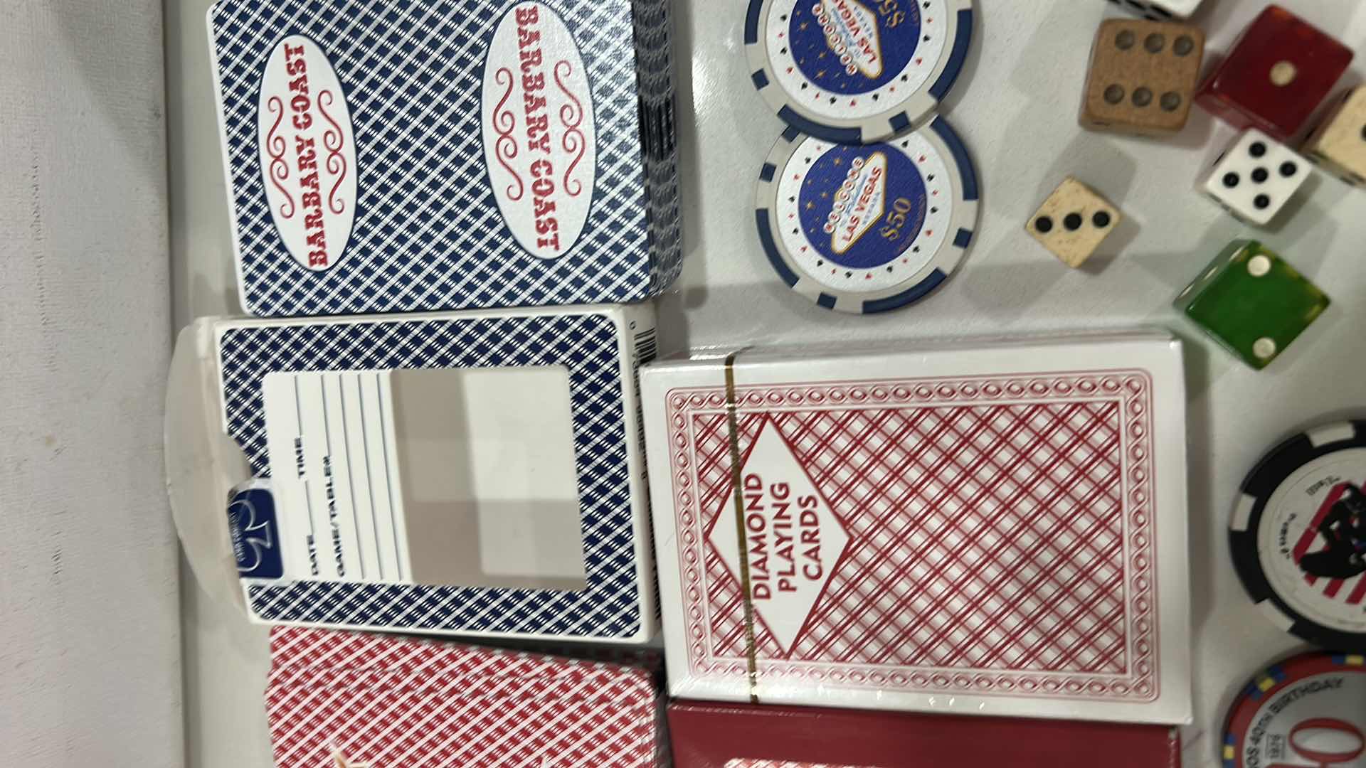 Photo 1 of LAS VEGAS CASINO PLAYING CARDS, DICE, 6 $50 REPLICA CHIPS AND 1 REAL CHIP, 1 COMMEMORATIVE TOKEN