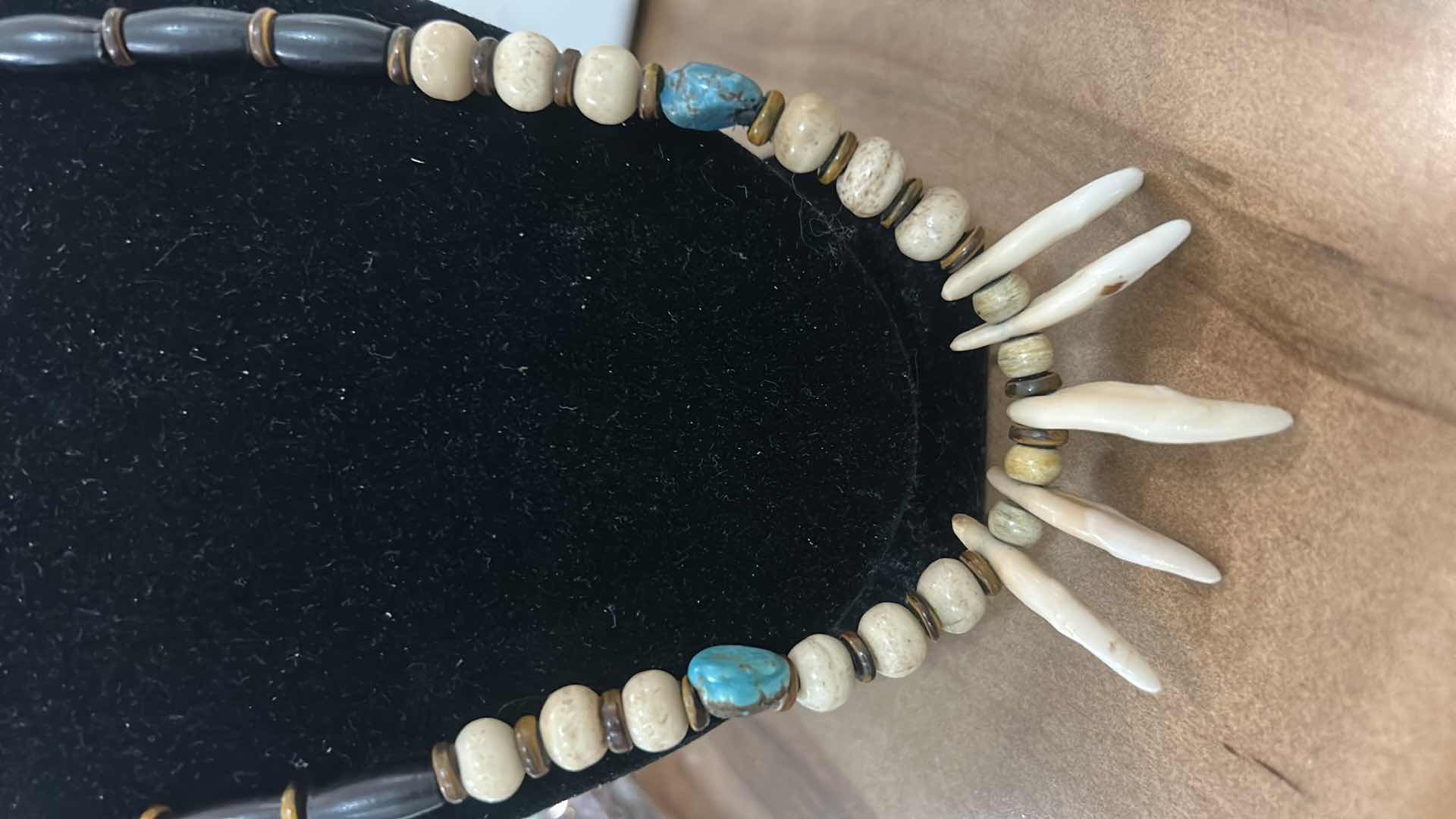 Photo 1 of SHAMAN STYLE NECKLACE FEATURING A COMBINATION OF NATURAL ELEMENTS, COMMONLY INCLUDING BUFFALO BONE BEADS, TURQUOISE STONES, AND EITHER ALLIGATOR OR BUFFALO TEETH. SUCH PIECES ARE OFTEN HANDCRAFTED AND MAY INCORPORATE MATERIALS LIKE SINEW AND WOOD ACCENTS.
