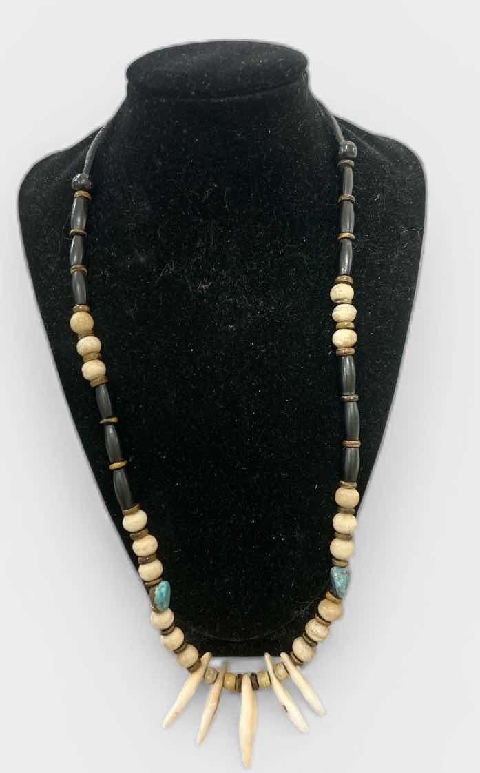 Photo 1 of SHAMAN STYLE NECKLACE FEATURING A COMBINATION OF NATURAL ELEMENTS, COMMONLY INCLUDING BUFFALO BONE BEADS, TURQUOISE STONES, AND EITHER ALLIGATOR OR BUFFALO TEETH. SUCH PIECES ARE OFTEN HANDCRAFTED AND MAY INCORPORATE MATERIALS LIKE SINEW AND WOOD ACCENTS.