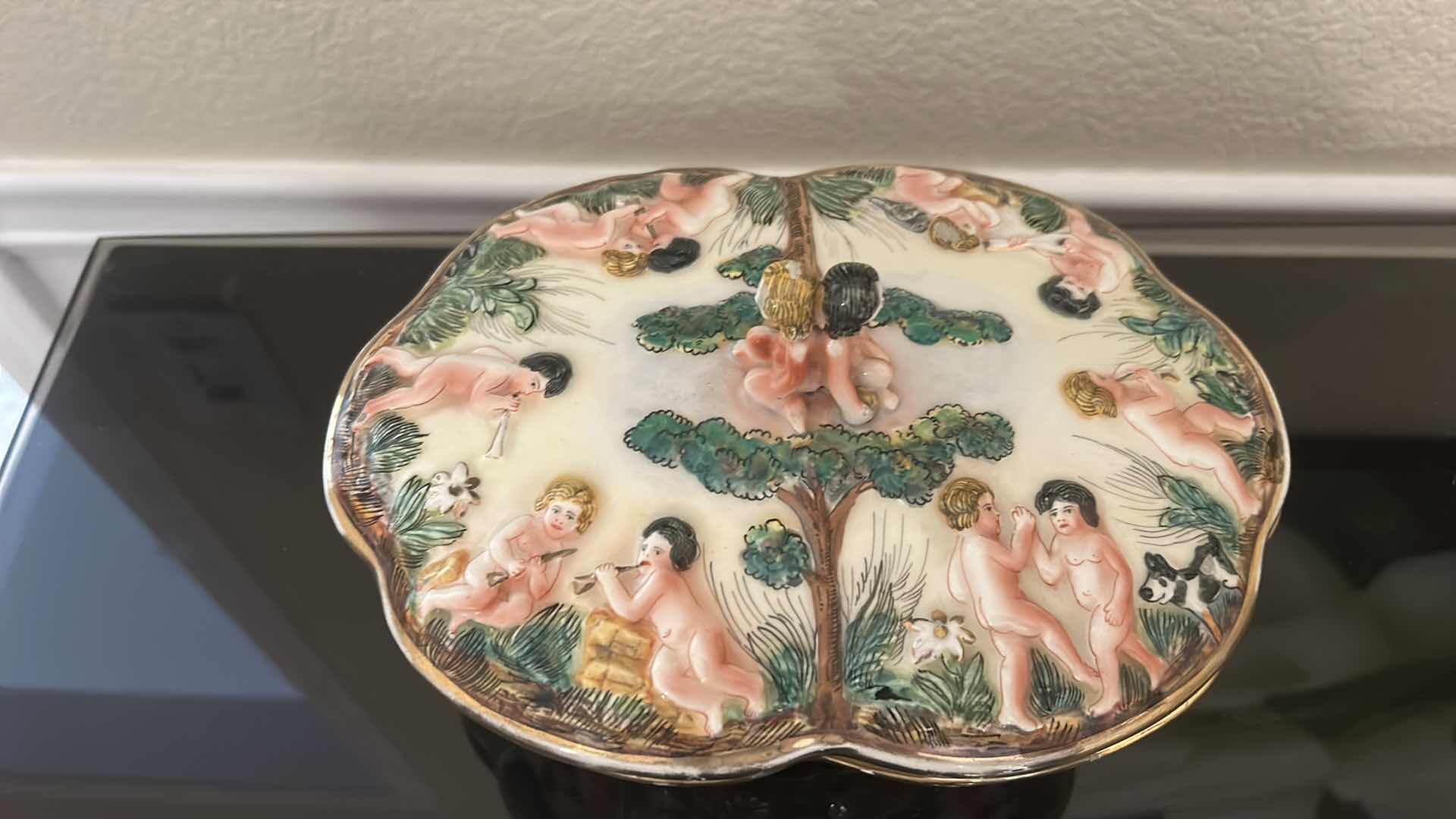 Photo 1 of ANTIQUE CAPODIMONTE ITALIAN PORCELAIN DRESSER SET FEATURING RAISED RELIEF DESIGNS OF CHERUBS .
•THE SET INCLUDES A LARGE LIDDED BOX, A SMALLER LIDDED JEWELRY BOX, AND A SMALL OPEN TRAY.   LARGEST 9 1/4” x 7 1/4” x H5 1/2”