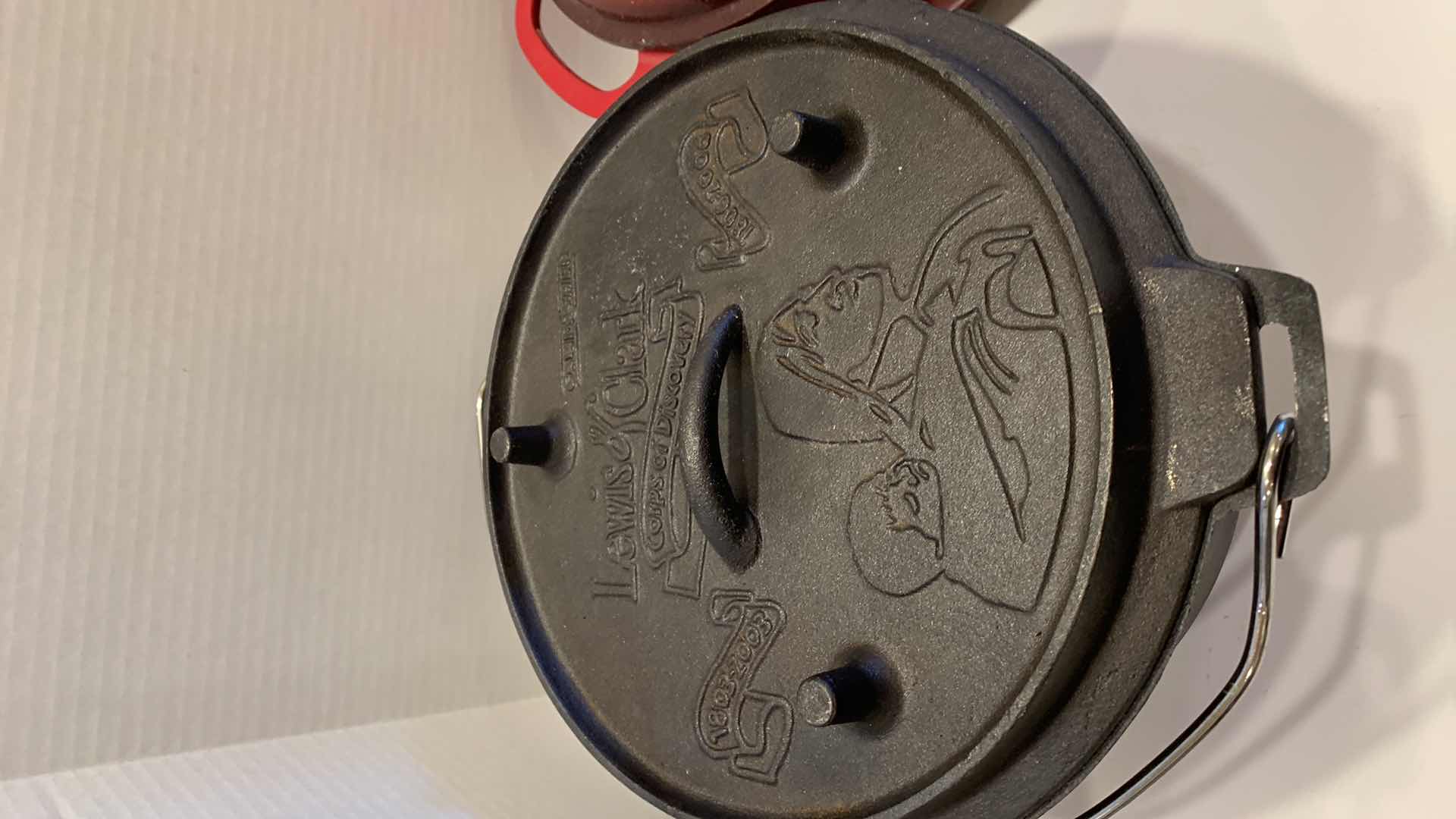 Photo 1 of 2-CAST IRON COOKWARE PIECES, LODGE AND LEWIS AND CLARK 6 QT