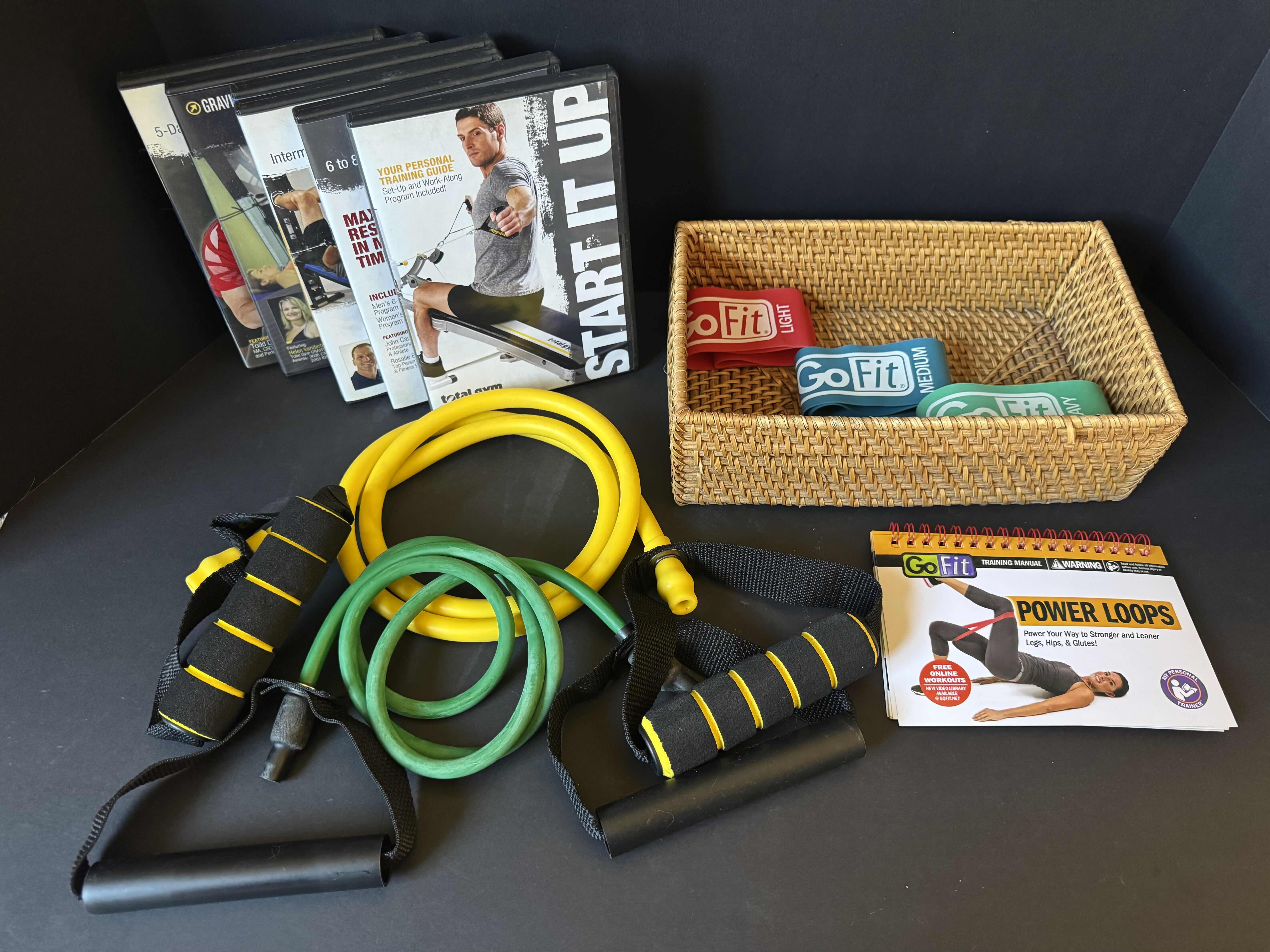 View 3 of ASSORTED EXERCISE ITEMS, RESISTANT BANDS, 6 TOTAL GYM DVD’S, TRAINING MANUAL, EXERCISE RESISTANCE BAND WITH HANDLES, WICKER BASKET.