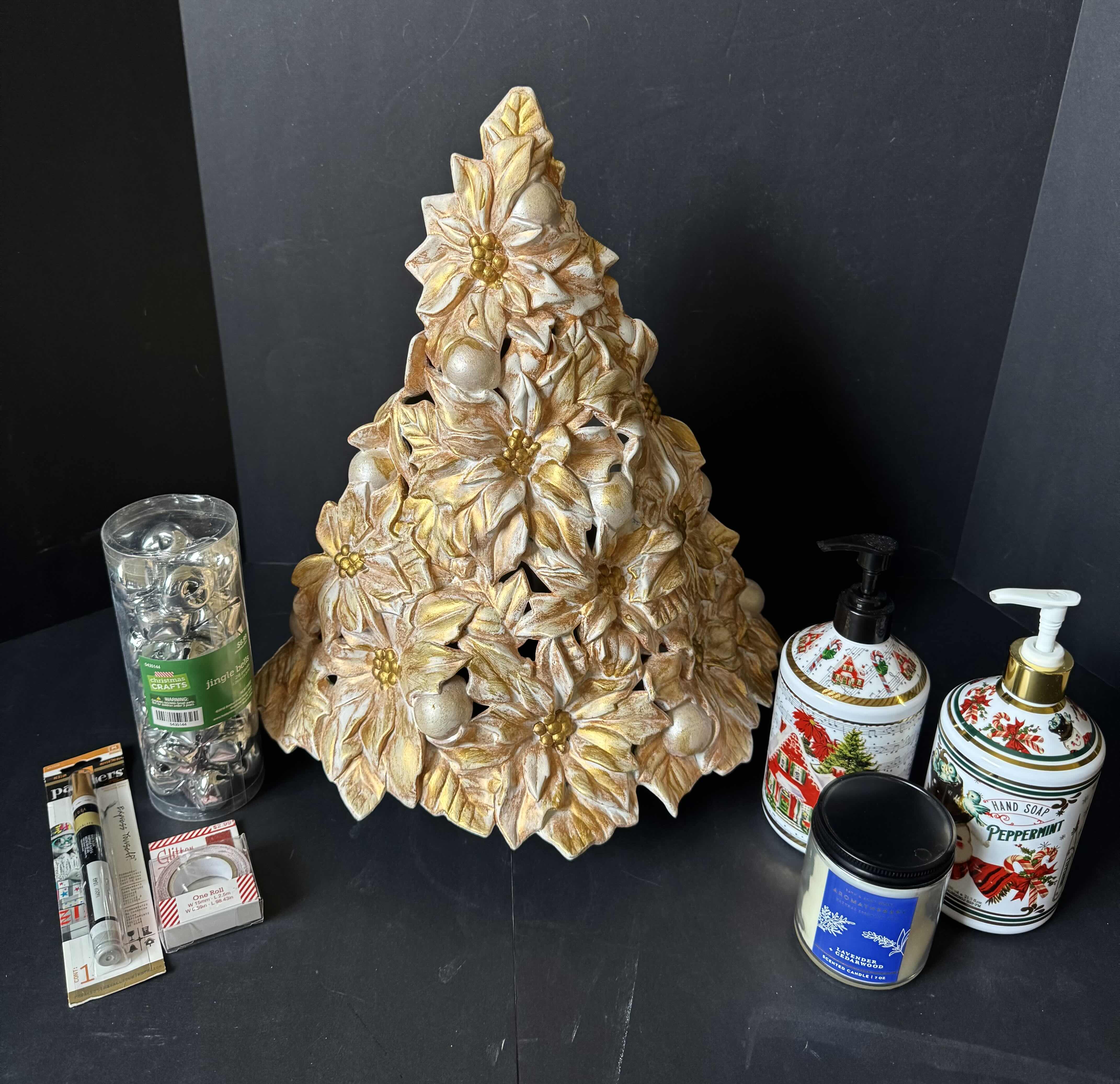 Photo 1 of ASSORTED HOLIDAY DECOR, CHRISTMAS DECOR, CERAMIC POINSETTIA CHRISTMAS TREE, 2 HANDSOAP, CANDLE, JINGLE BELLS, PAINT MARKER, ONE ROLL GLITTER TAPE