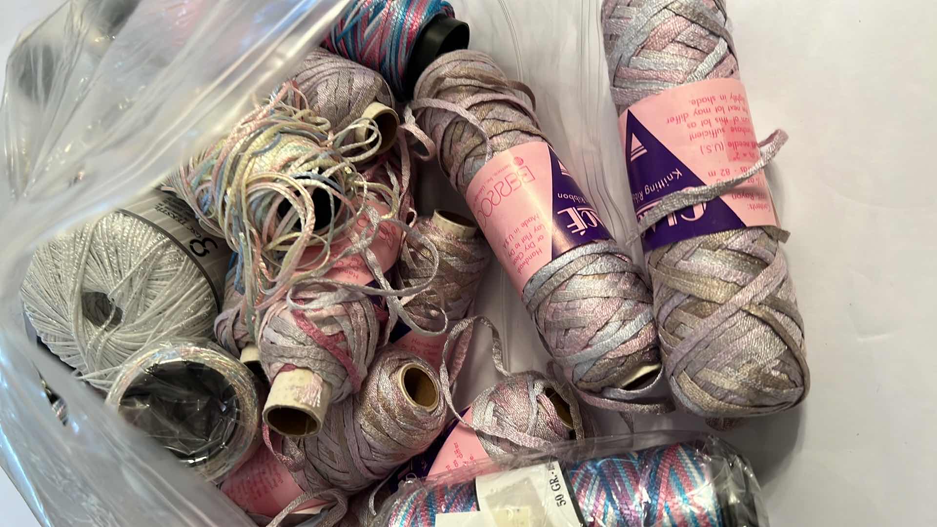 Photo 1 of BAG OF BOBBINS AND SKEINS OF KNITTING RIBBON AND THREAD