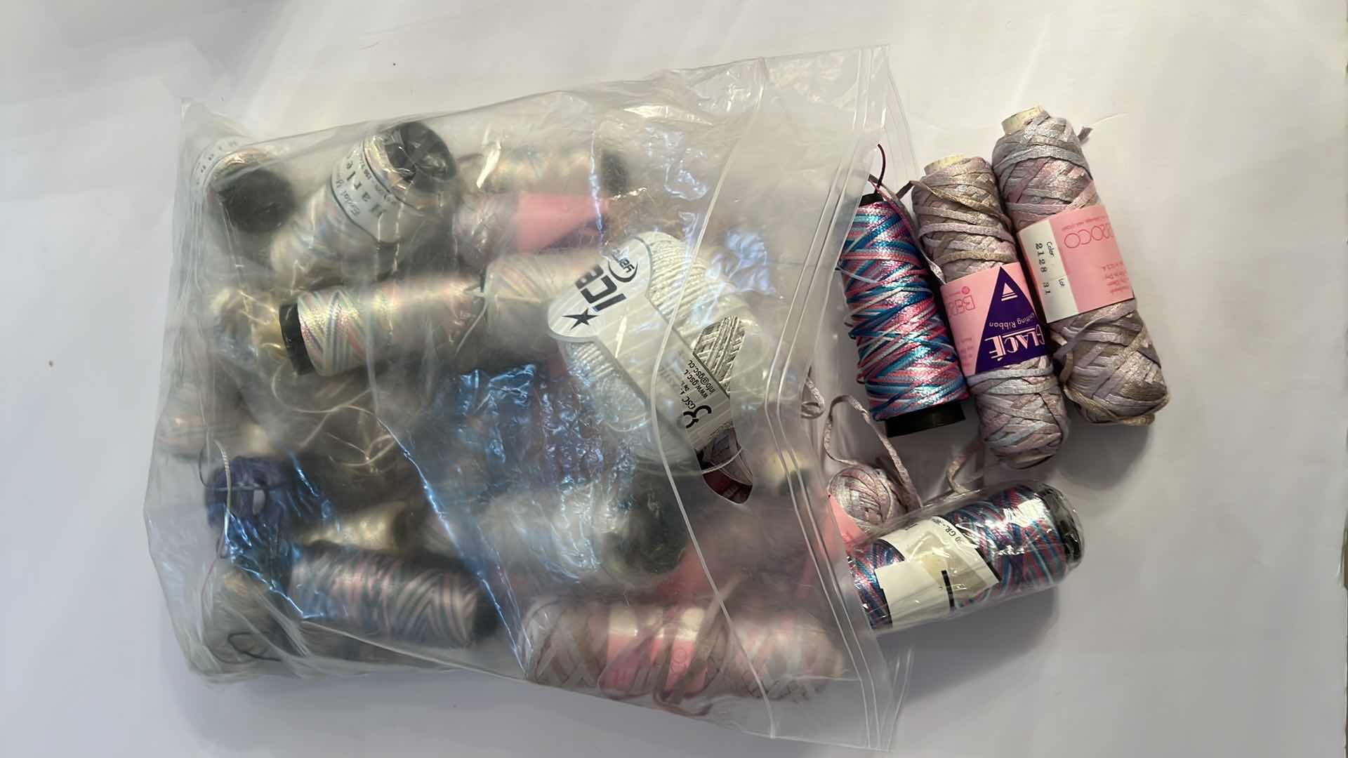 Photo 1 of BAG OF BOBBINS AND SKEINS OF KNITTING RIBBON AND THREAD
