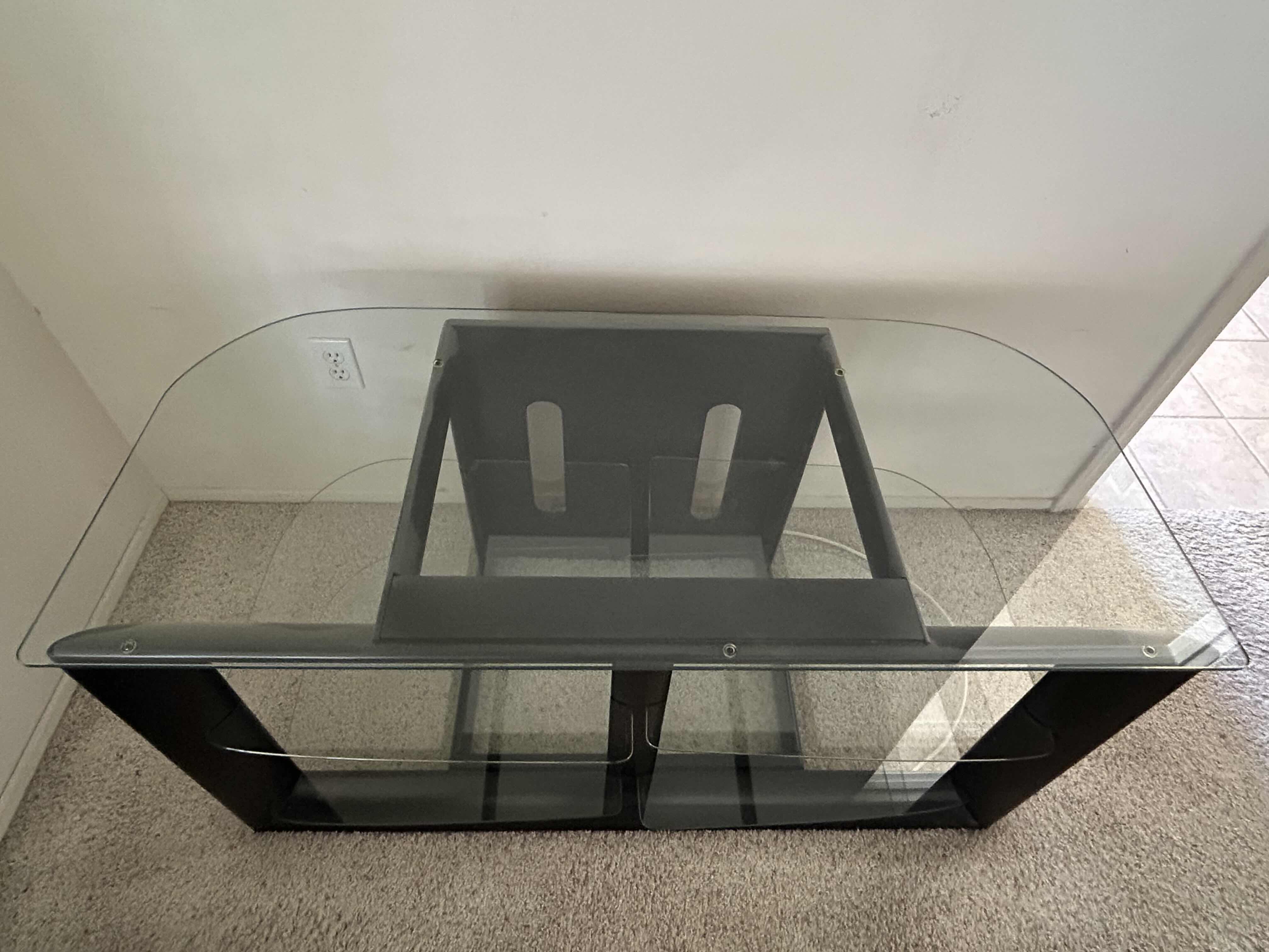 Photo 1 of BLACK AND GLASS ENTERTAINMENT CENTER 48” X 22” H 24”