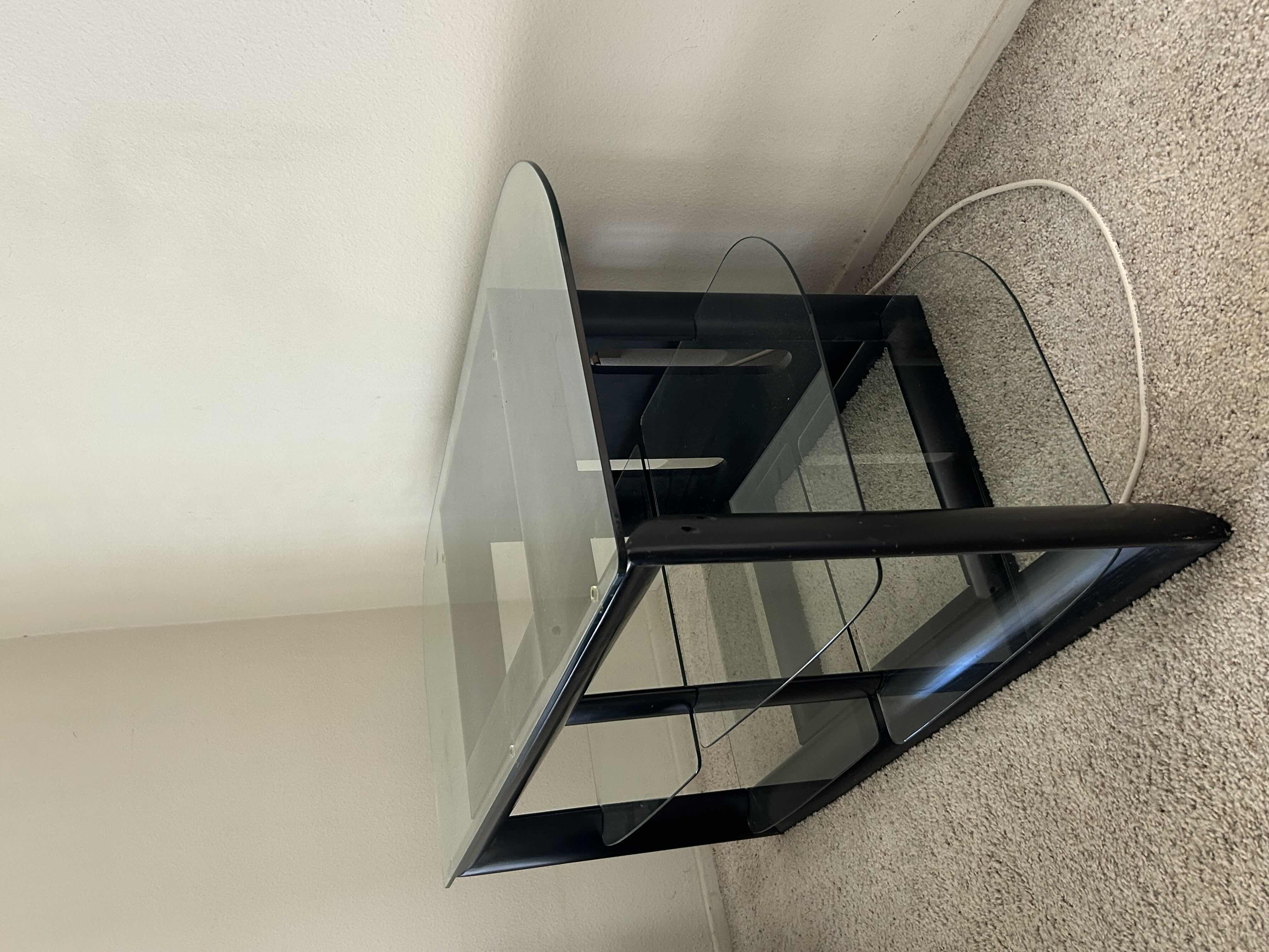 Photo 1 of BLACK AND GLASS ENTERTAINMENT CENTER 48” X 22” H 24”