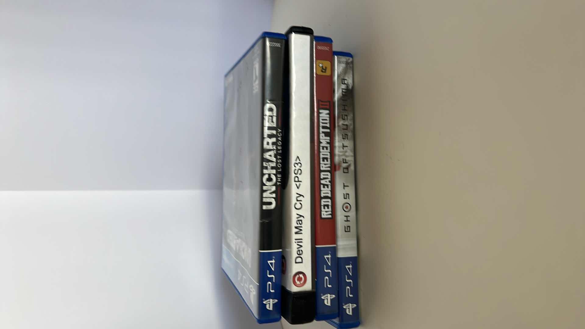 Photo 1 of 4-PS4 GAMES. DEVIL MAY CRY, UNCHARTED RED DEAD REDEMPTION, GHOST OF TSUSHIMA