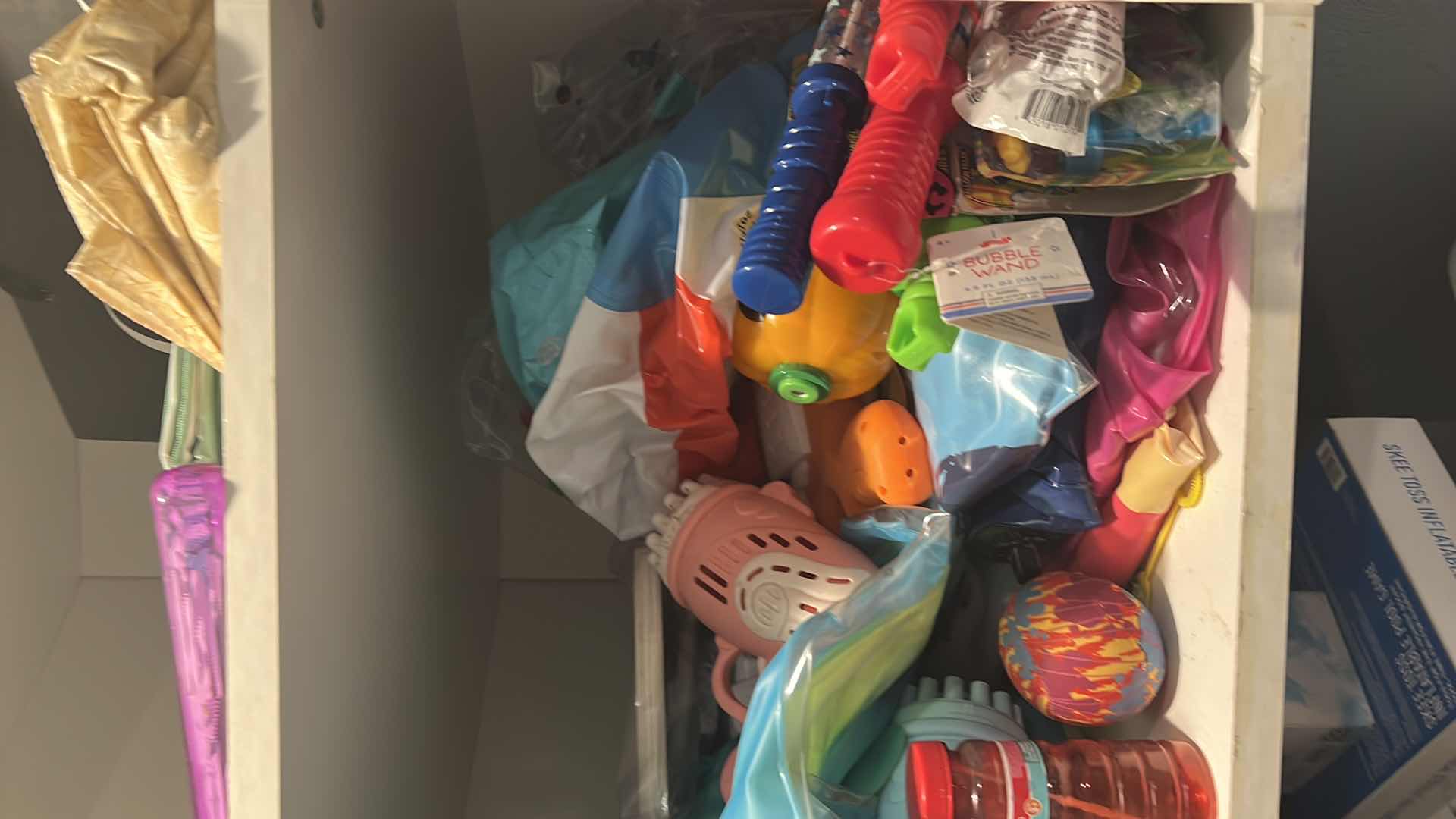 Photo 1 of CONTENTS OF LAUNDRY ROOM CABINET. KIDS TOYS WITH BUBBLE MAKERS, BLOW UP POOL FLOATIES, ETC..