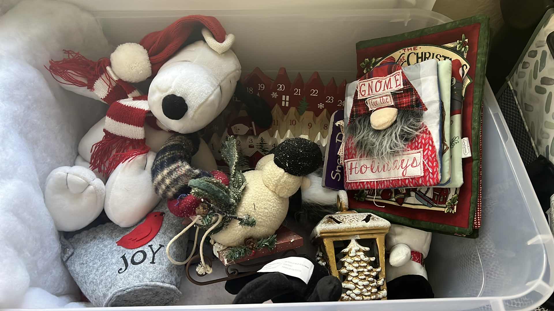 Photo 1 of CONTENTS OF BOX-CHRISTMAS DECOR, ADVENT CALDENDAR, SNOOPY STUFFY, SNOWMAN, AND SOFT CHILDRENS BOOK...ETC..