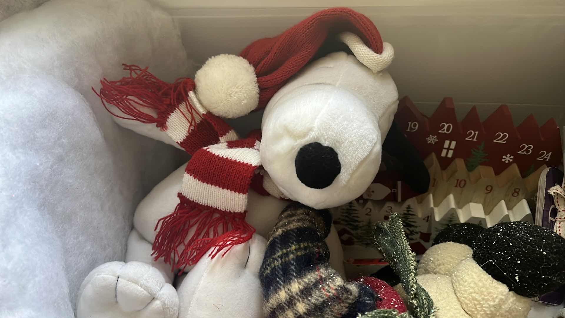 Photo 1 of CONTENTS OF BOX-CHRISTMAS DECOR, ADVENT CALDENDAR, SNOOPY STUFFY, SNOWMAN, AND SOFT CHILDRENS BOOK...ETC..