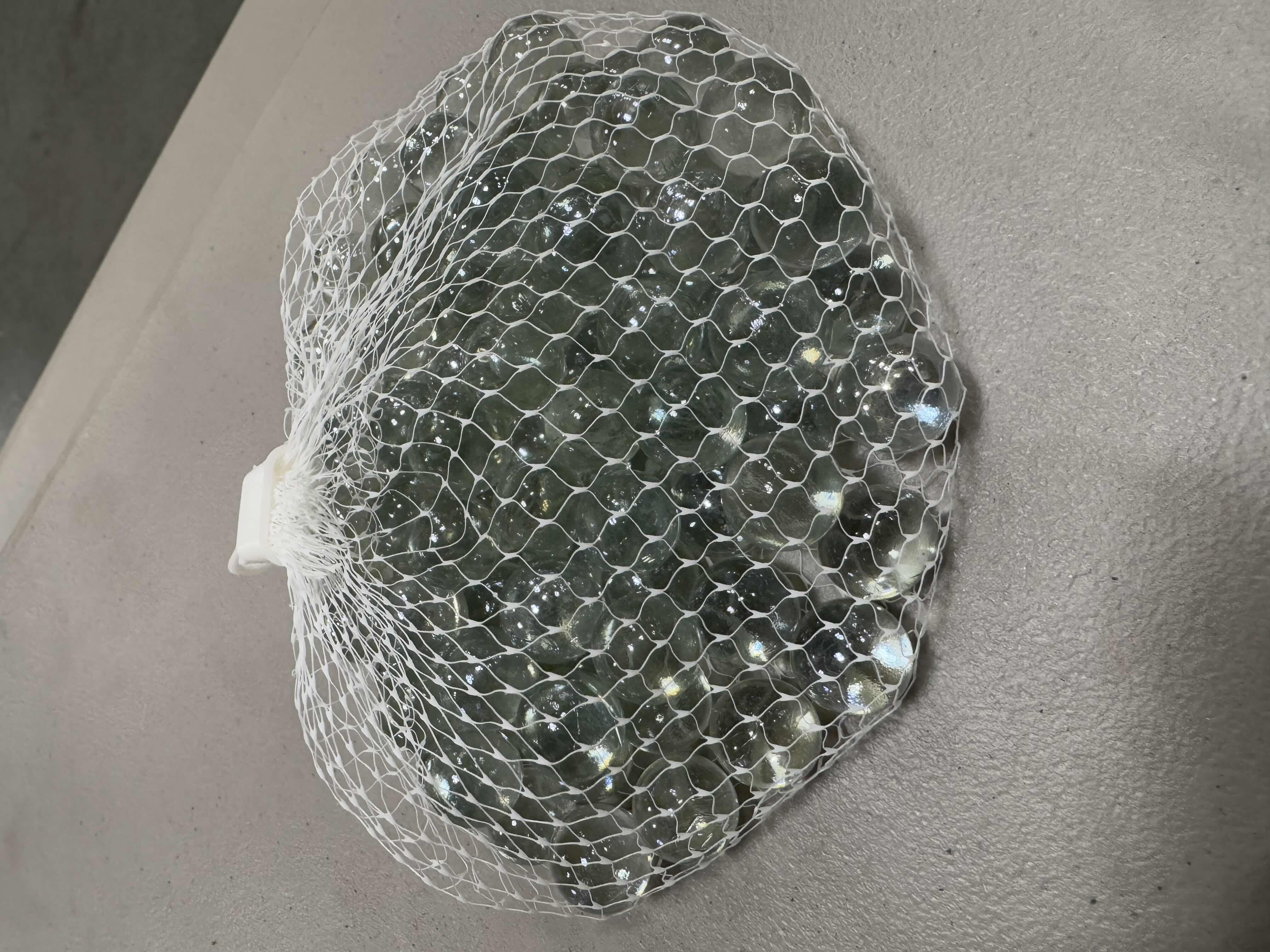 Photo 1 of BRAND NEW CASE OF DECORATIVE MARBLES IN LIGHT GREENISH GREY. 15 BAGS PER BOX