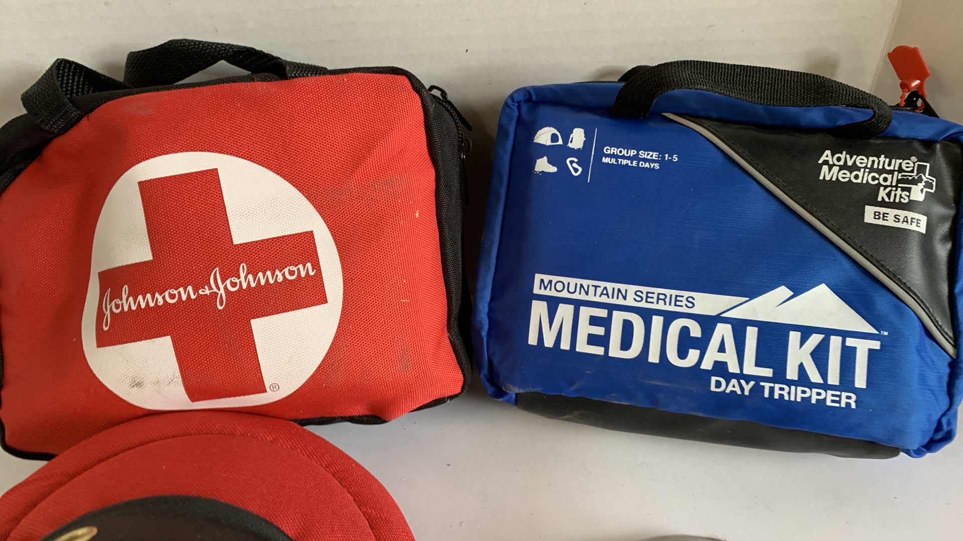 Photo 1 of 2 FIRST AID KITS, KNEE PADS AND A PEDOMETER