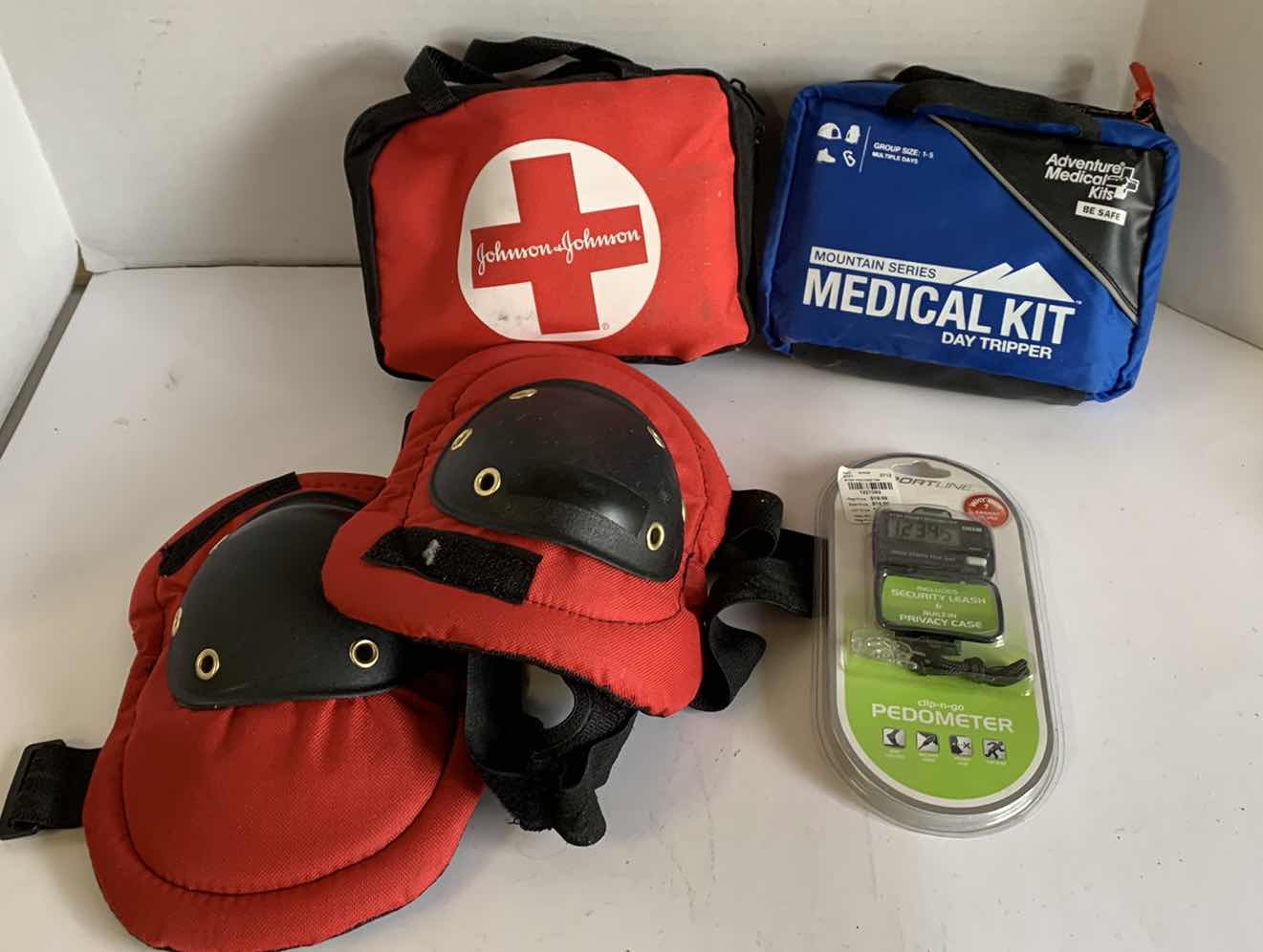 Photo 1 of 2 FIRST AID KITS, KNEE PADS AND A PEDOMETER